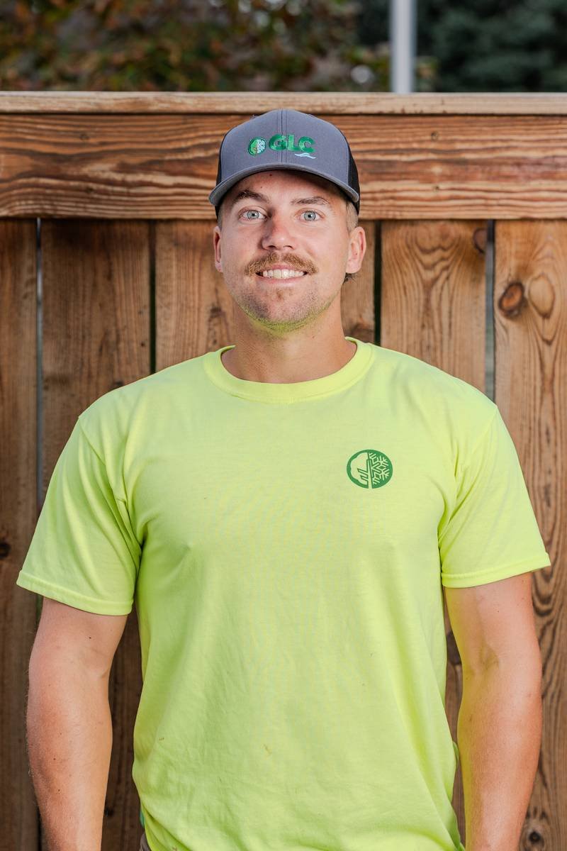 Khen, Landscape Foreman, in a yellow GLC T-shirt and cap — GLC Landscaping & Pools
