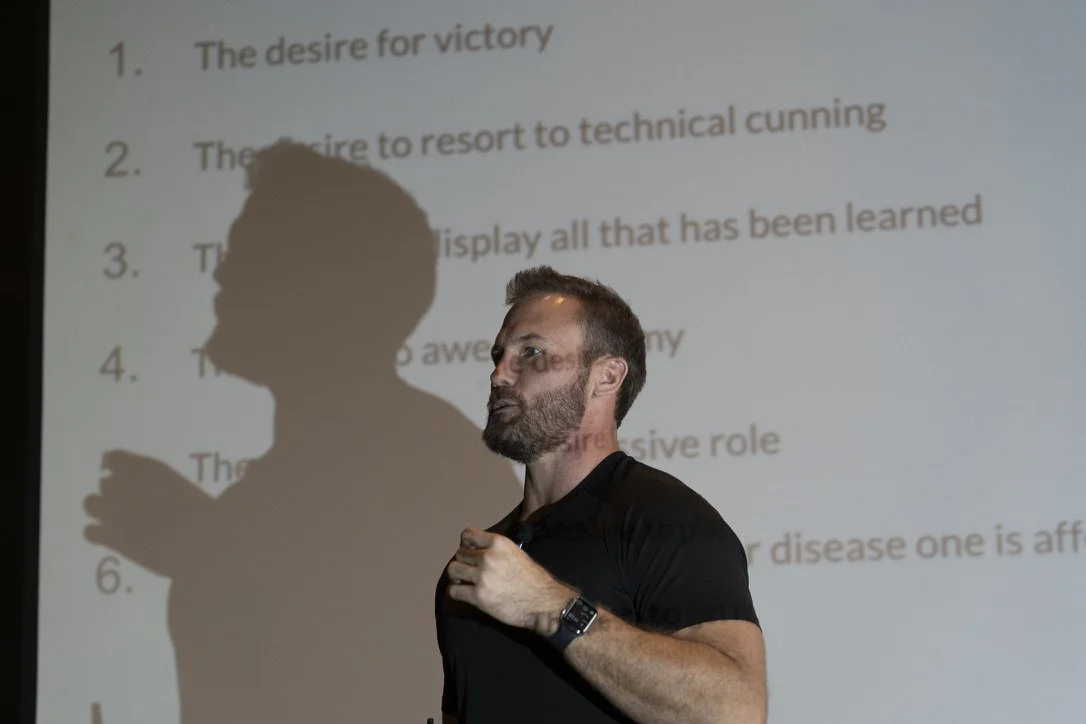 Michael Bann presenting during a lecture in front of a projection screen