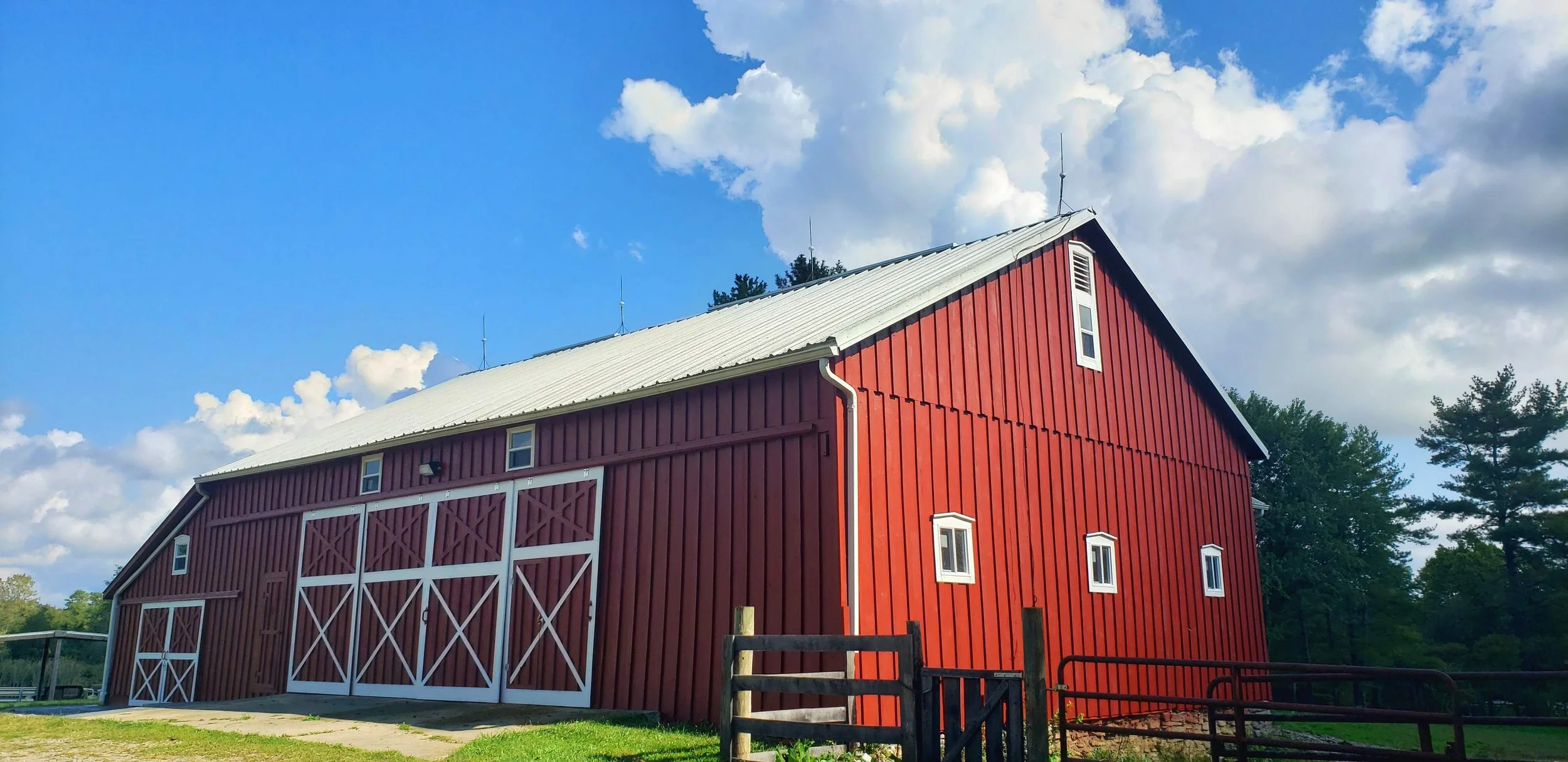 Red barn with white trim on a nice summer day