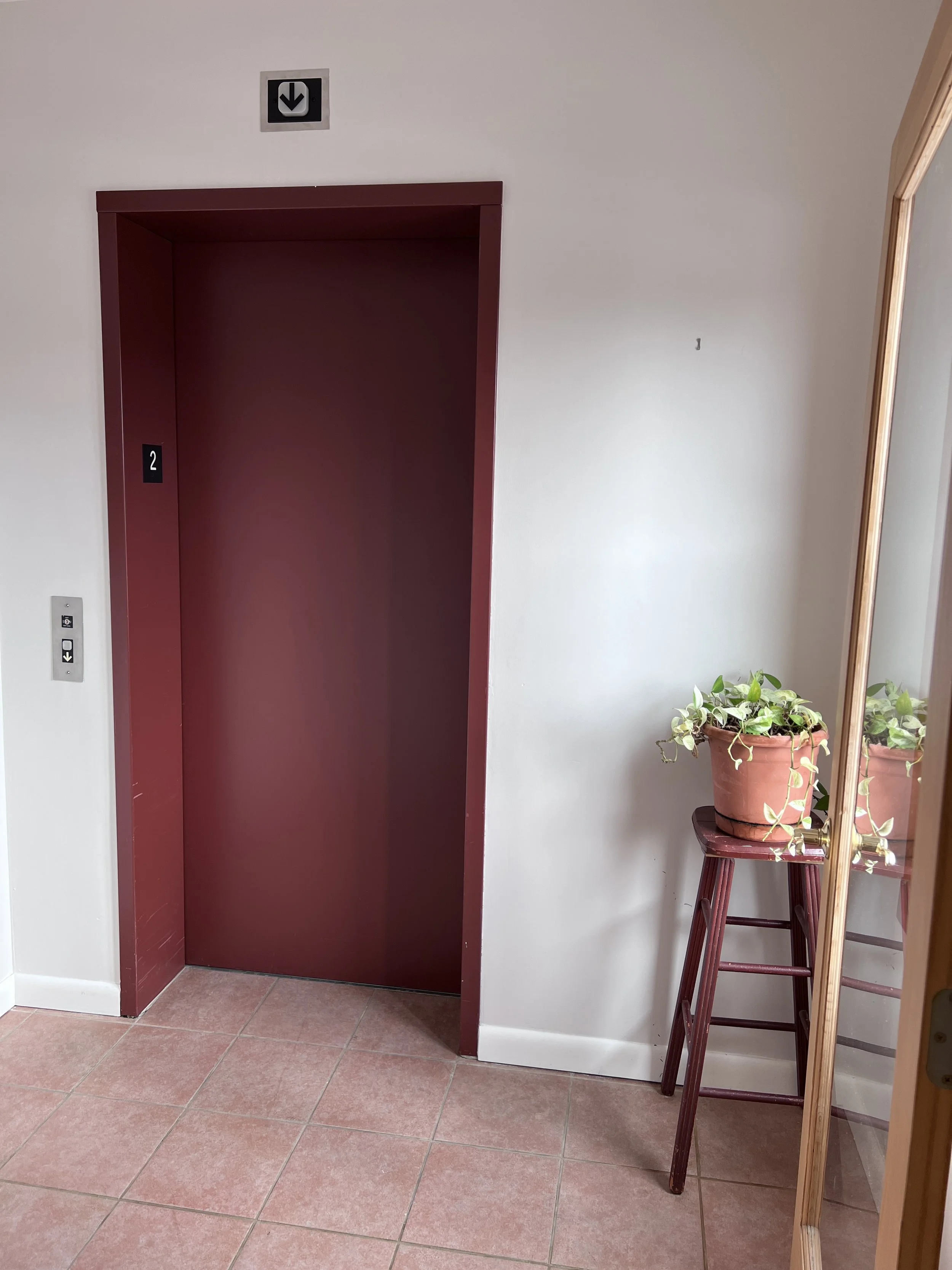 From the parking lot, the elevator entrance is located to the right. 