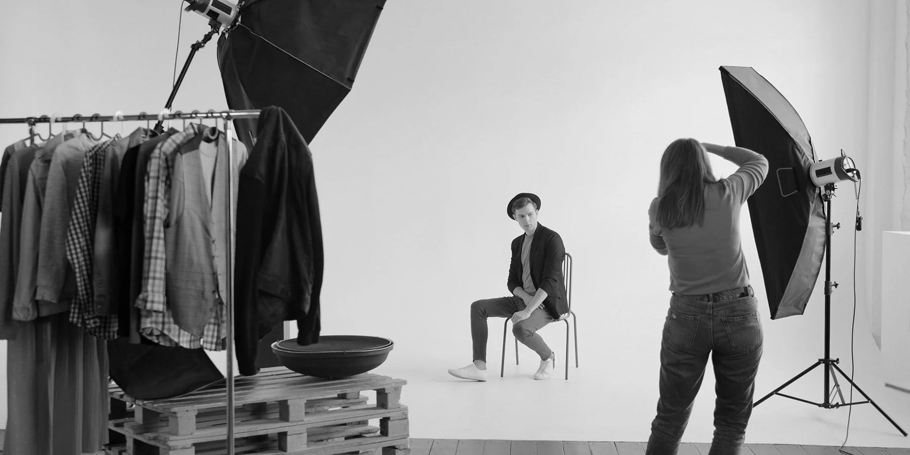 Photo session with a male model and female photographer.