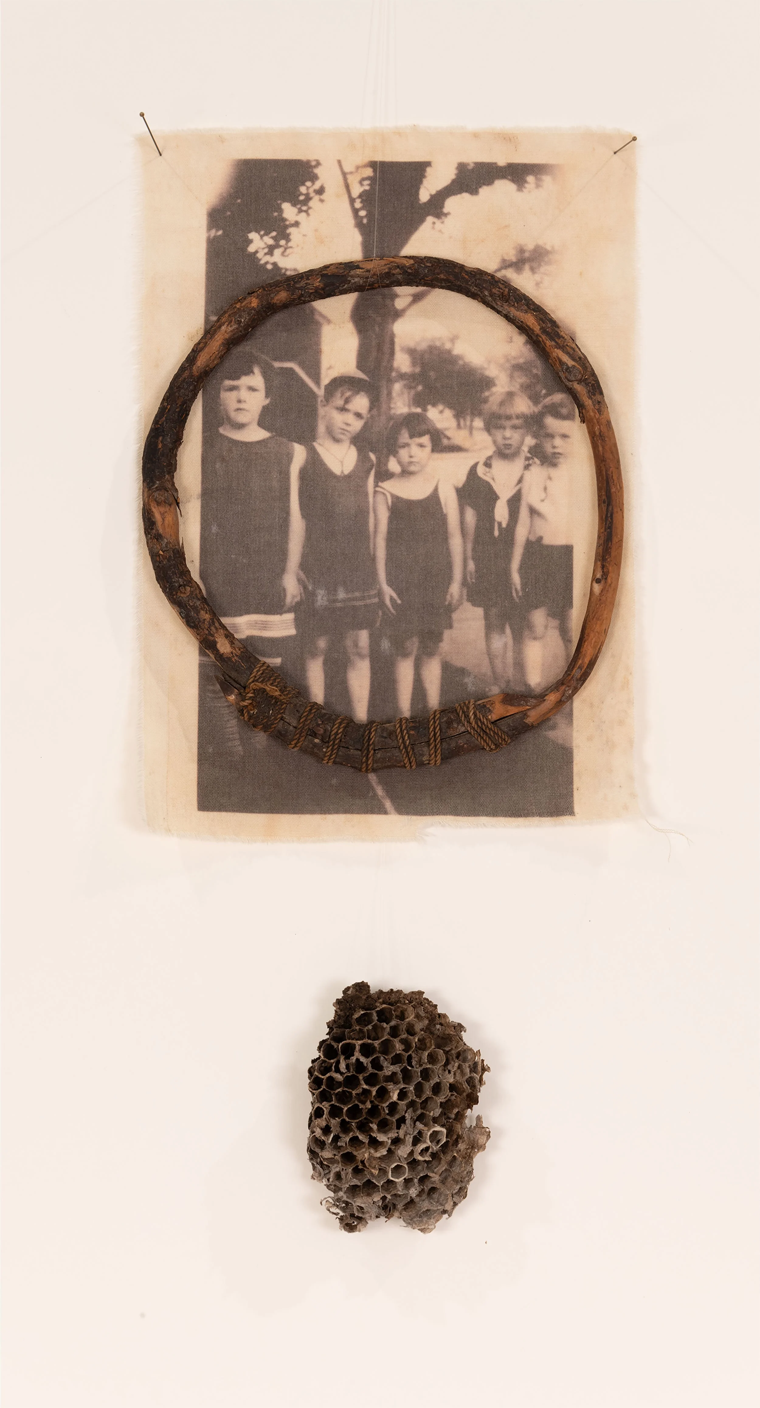 Hive - vintage family photograph printed on vintage muslin, vintage lobster trap hoop, found beehive, nylon thread, straight pins
14 x 6 inches