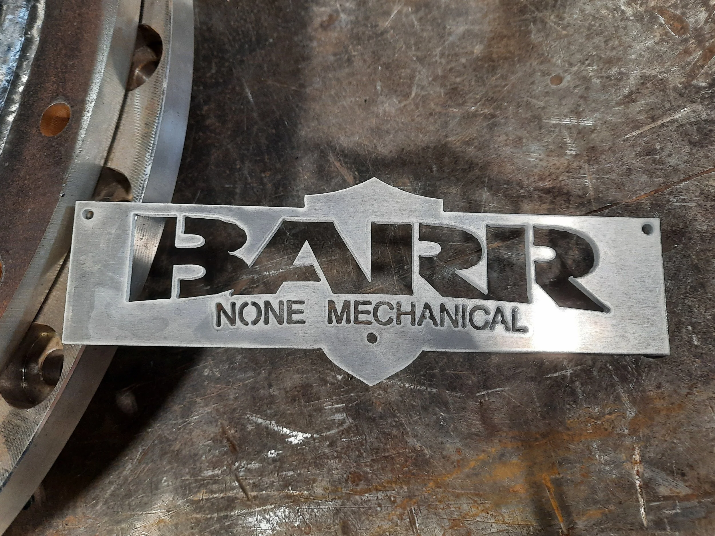 Metal sign with the words "Barr None Mechanical" cut out.