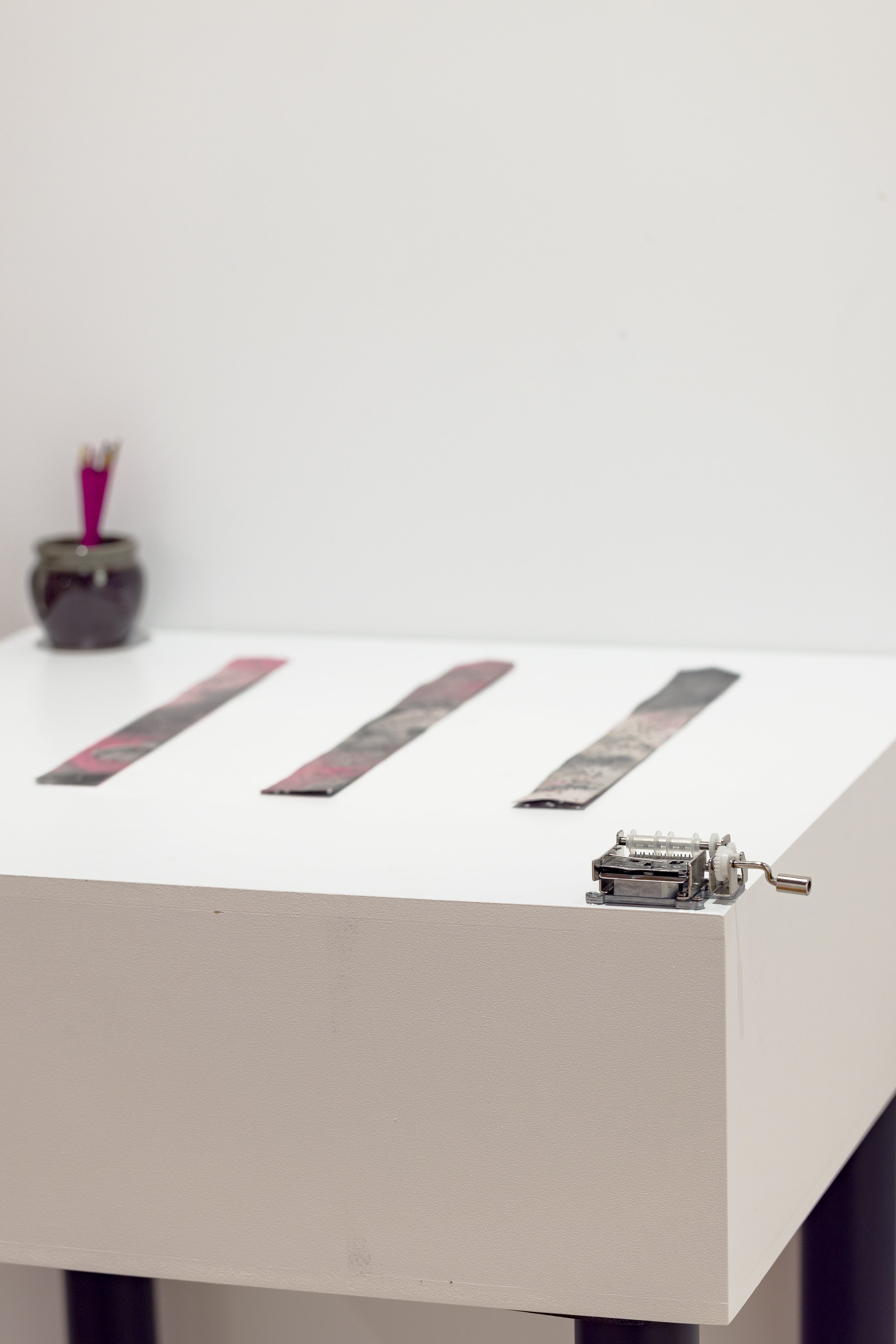 "Twin Melody for Music Box (Flowers)", 2025, acrylic and ink on xuan paper, treated and hole-punched xuan paper, hand-cranked music box, 4 x 35 cm. Photo: Document Photography.