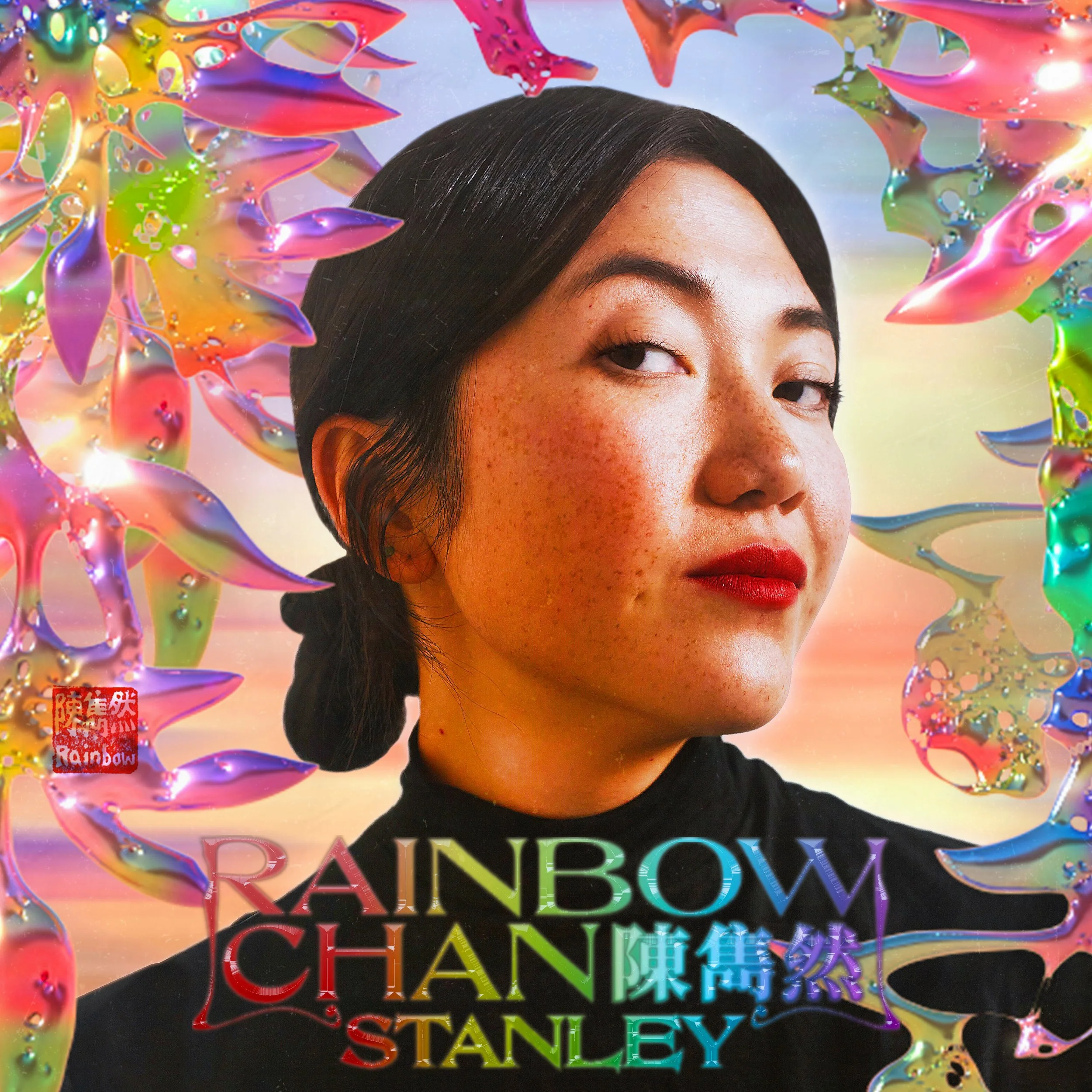 A portrait of a woman with freckles, dark hair tied back, red lipstick, and a black top, surrounded by colorful, abstract, rainbow-like shapes and a pastel sky background, with text greeting "Rainbow Chan Stanley" in rainbow colors.