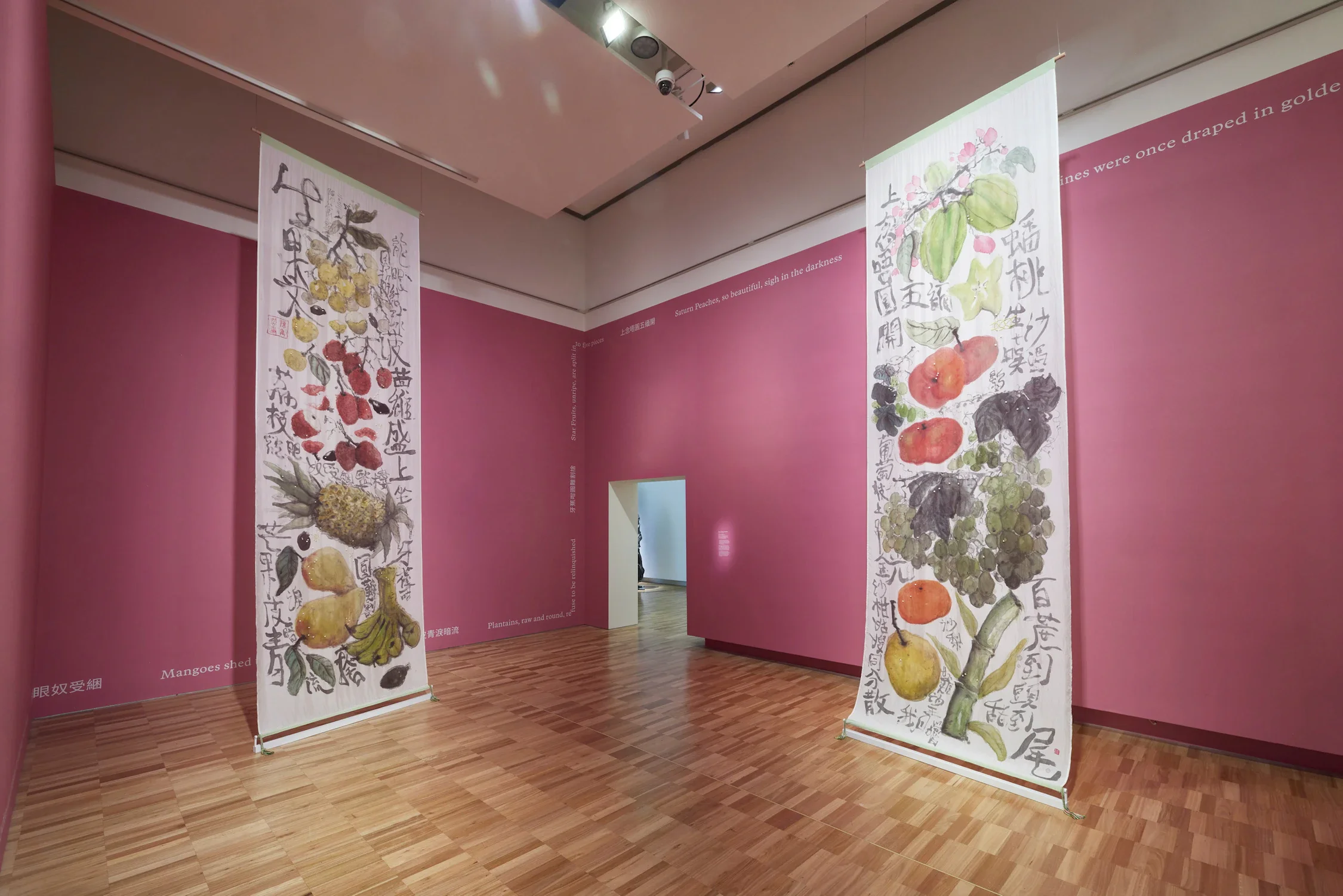 "Fruit Song 生果文", 2022, habotai silk, silk dye, freshwater pearls, 花带 patterned
braids, linocut print, polyamide thread, cotton, vinyl lettering, wall paint, multichannel audio (5:20 minutes),
dimensions variable. "And Still I Rise" installation view