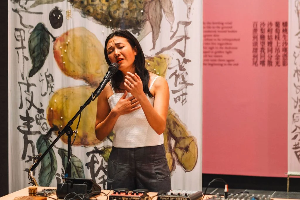 Rainbow Chan with "Fruit Song" (2022). Live musical performance at the opening of "Assembly", CIW Gallery, Canberra (15 February 2024). Photo: Tim Ngo.