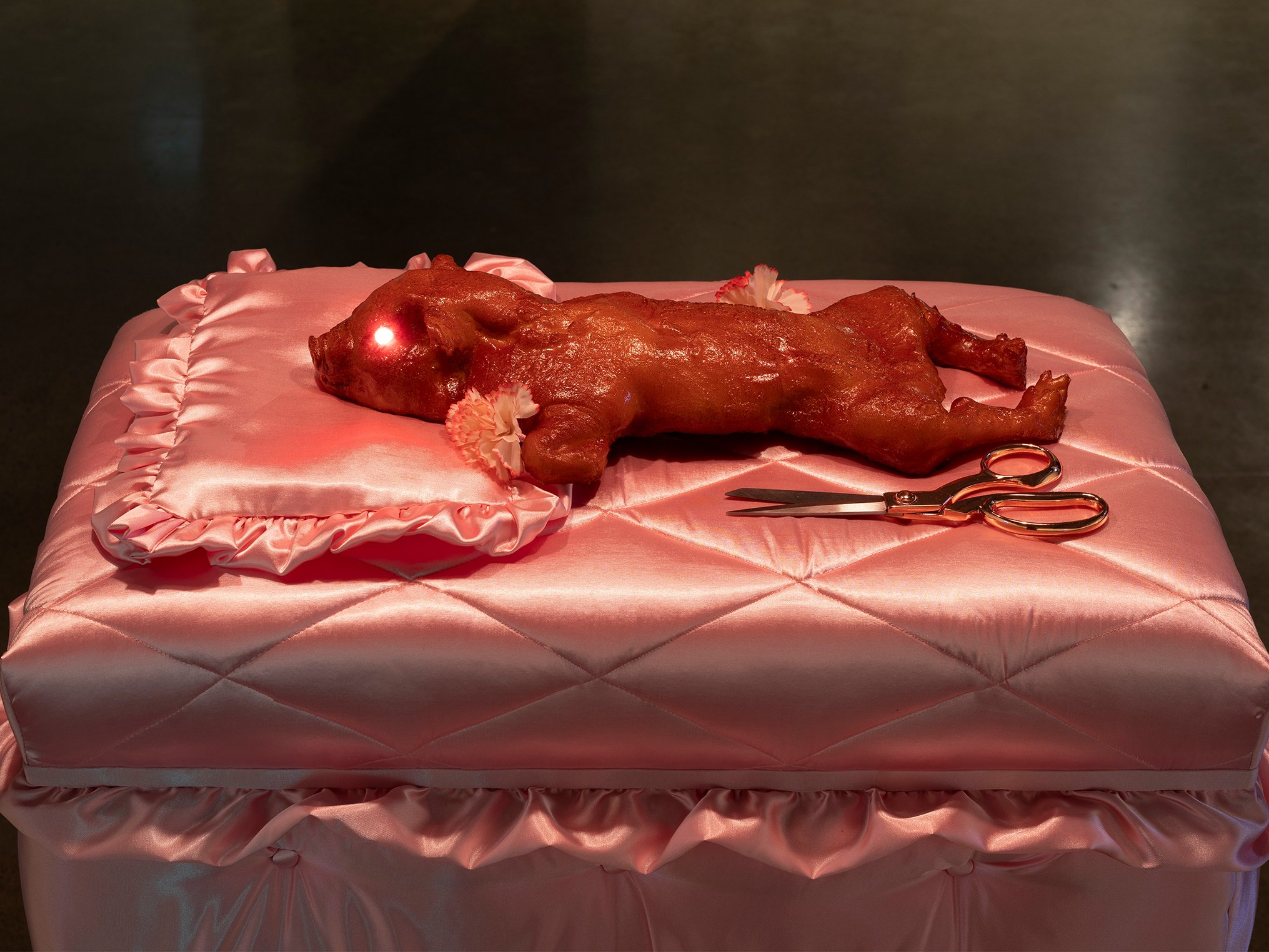 "Chastity Pig 宮紗珠", 2024. Foam, latex, shellac, LED bulbs, MDF board, satin, scissors, wet market red lamps. Photo: Jessica Maurer.