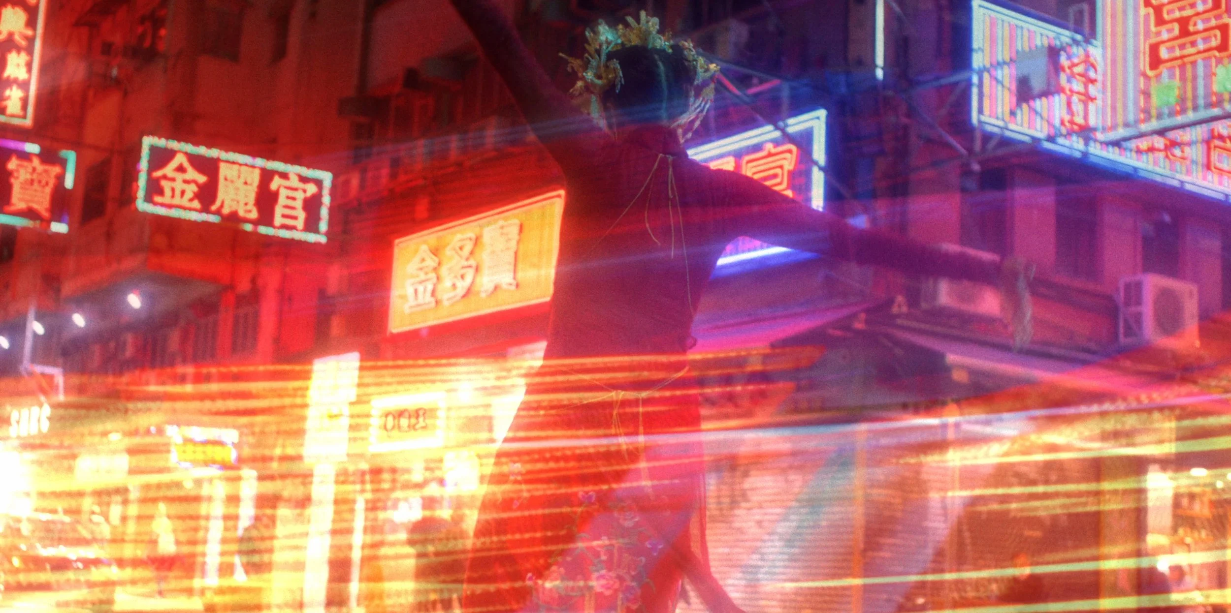 A person with colorful hair and a hat, standing on a busy neon-lit street at night with streaks of light from passing cars, surrounded by illuminated signs with Chinese characters.