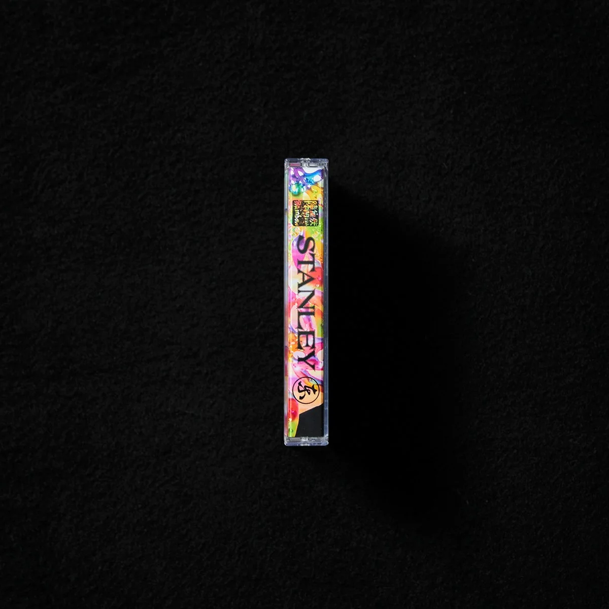 A colorful, holographic package with the word "STANLEY" on it, placed vertically against a black background.