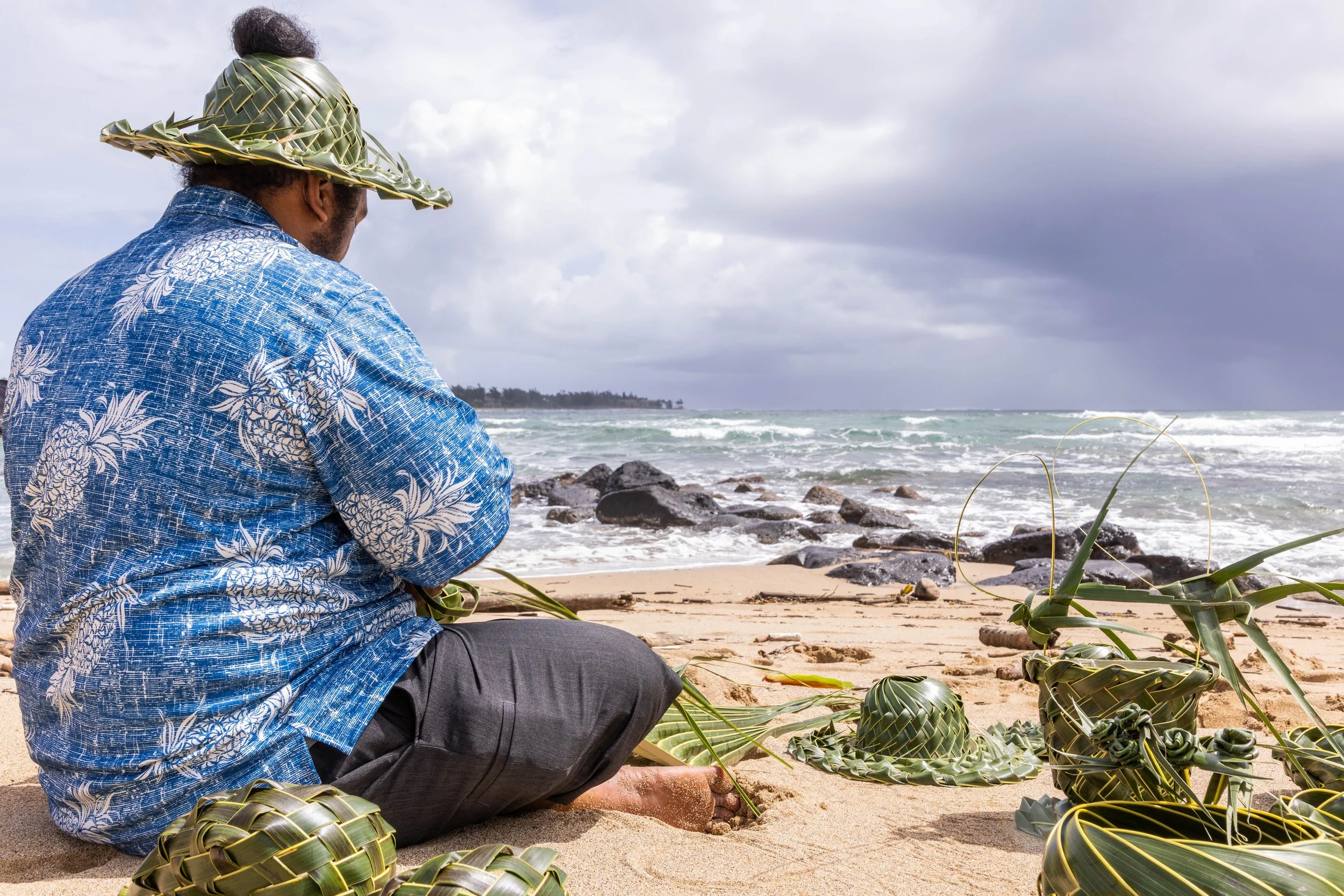 April 2023 - Jerome creating Papale Niu hats on a beach in Kauai.