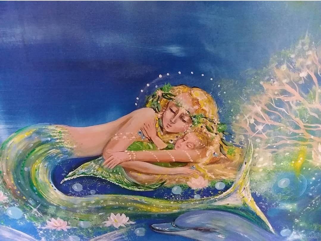 A mermaid with blonde hair and a green tail embraces a woman with blonde hair underwater surrounded by a glowing scene with fish, flowers, and sparkling lights.