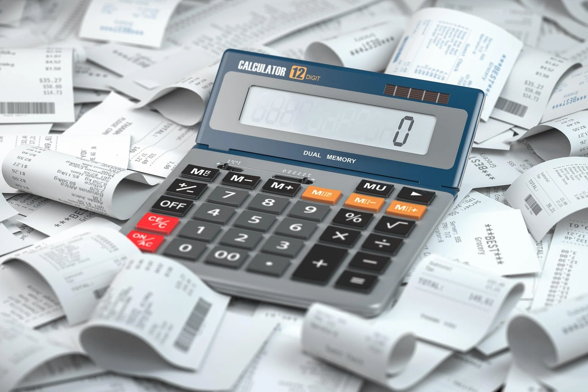 A calculator surrounded by crumpled receipts and sheets of paper with printed receipts and numbers.