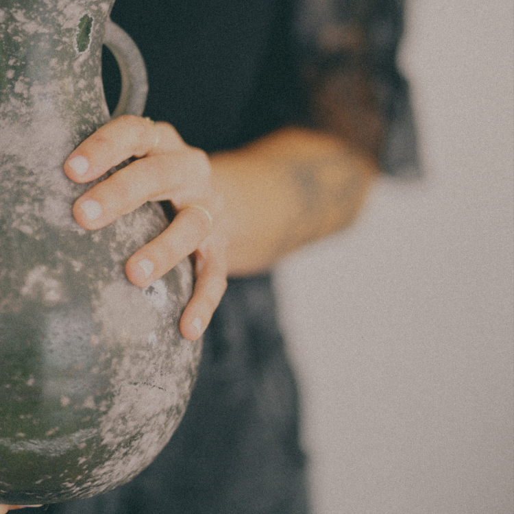 Close-up of a person’s hand gripping a rock climbing hold during indoor rock climbing exercise.