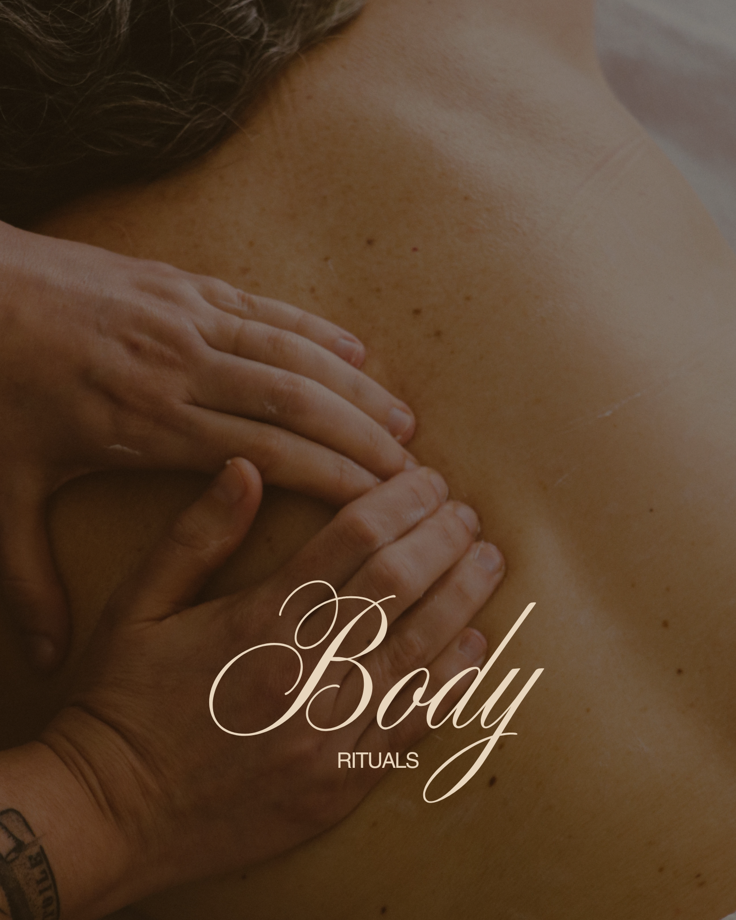 Close-up of a massage or body treatment, person receiving a back massage with hands applying gentle pressure, the image emphasizes the skin and back area, with the words 'Body Rituals' written on it.