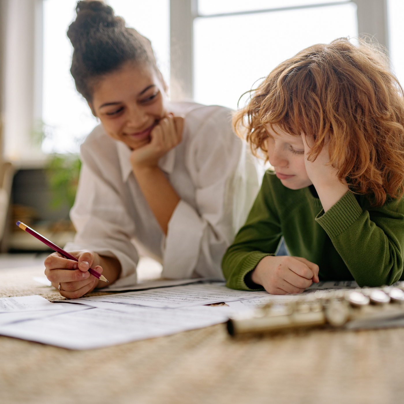 Caregiver providing one-on-one academic support to a child, helping build confidence, focus, and learning skills for Main Line and Chester County families.