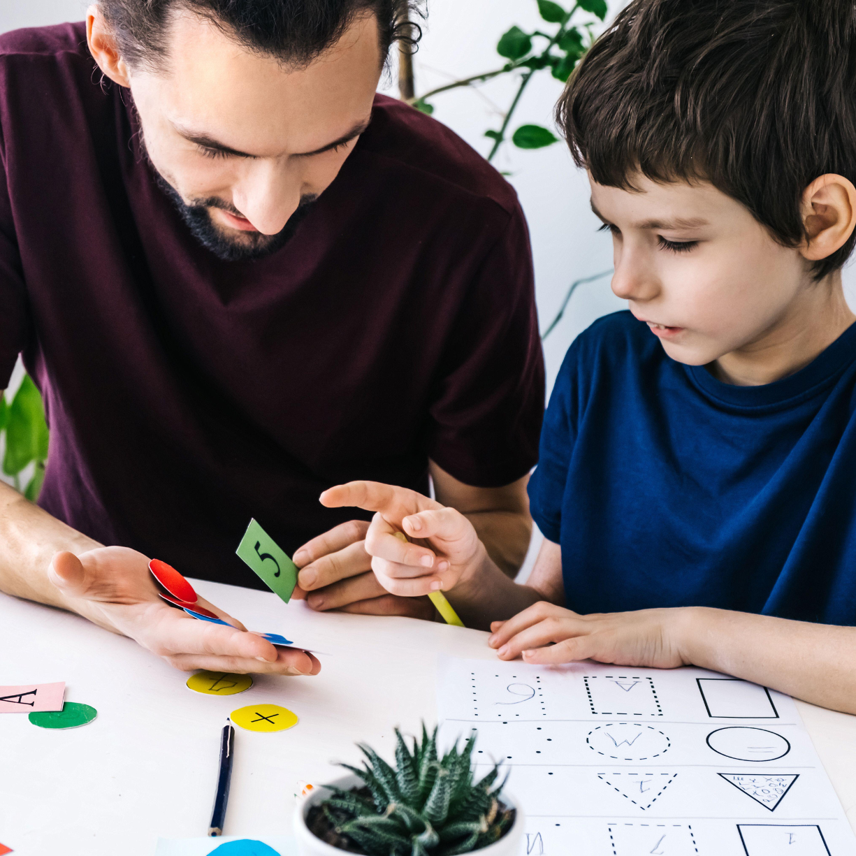 Caregiver and child engaging in educational activities that support learning, confidence, and development for Main Line and Chester County families.