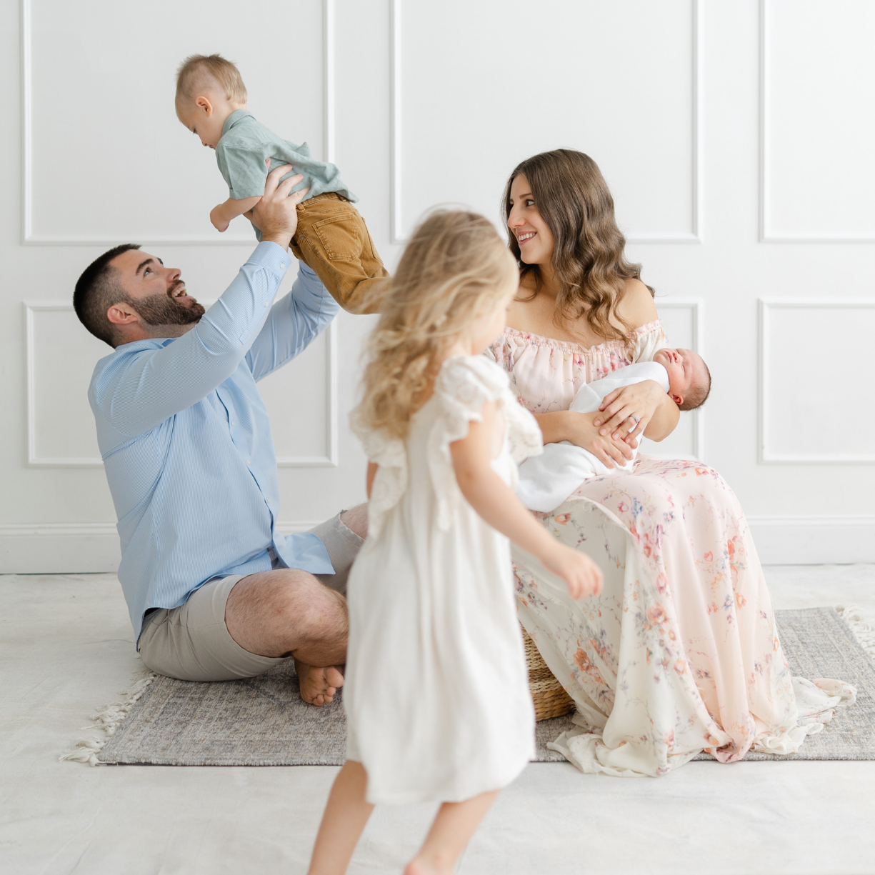 Happy family enjoying quality time together with their children and newborn, reflecting the trusted family support and childcare services offered throughout the Main Line and Chester County.