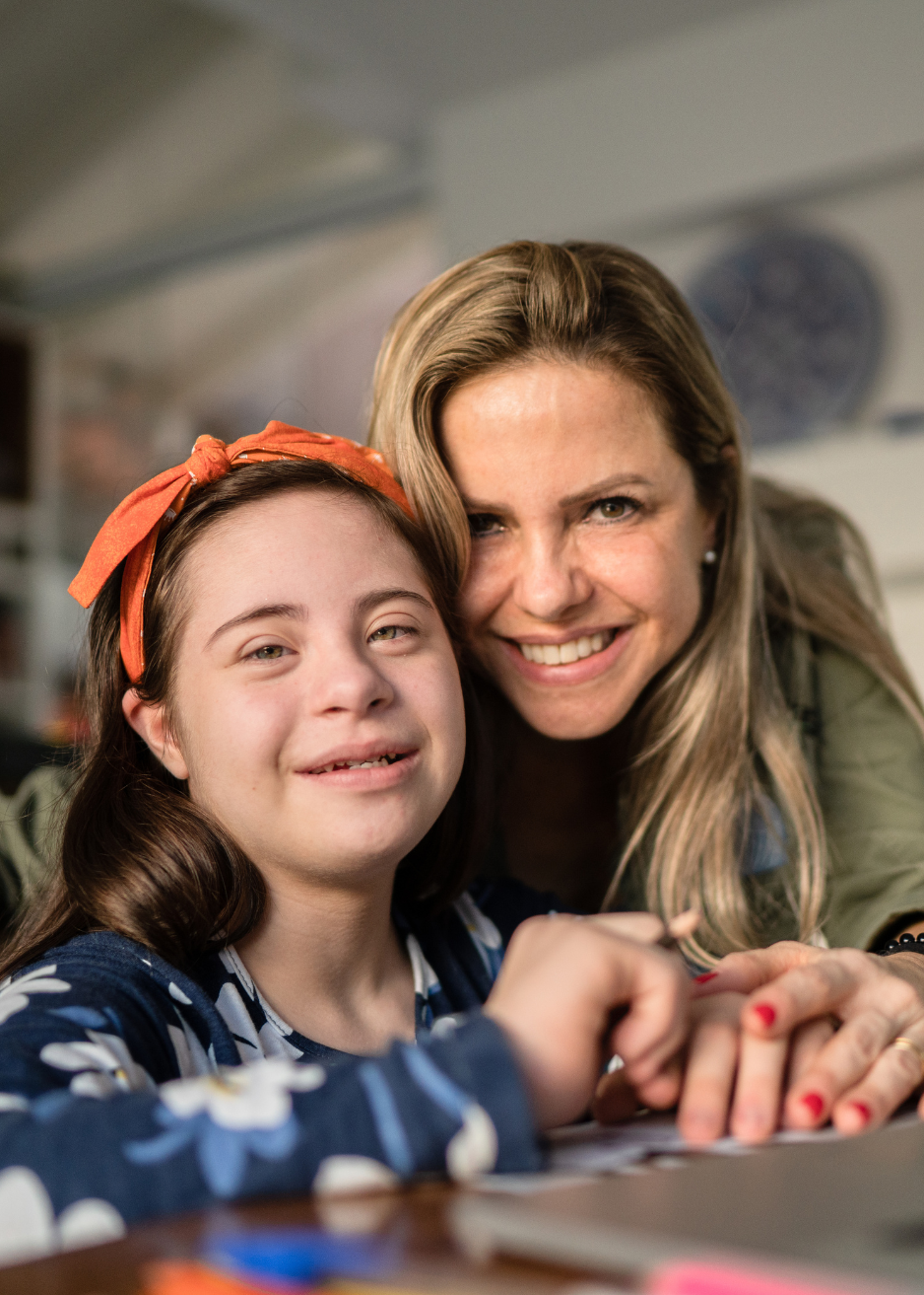 Caregiver and child sharing a joyful moment together, reflecting the trusted relationships and compassionate childcare support provided to Main Line and Chester County families.
