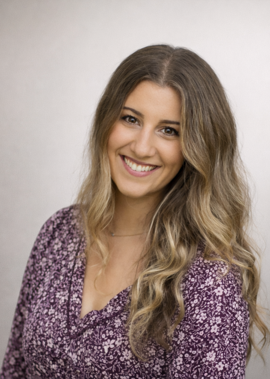 Rebecca Ryan, Founder of Balanced Babysitting, smiling in a floral blouse and bringing trusted childcare expertise and family support to Main Line and Chester County families.