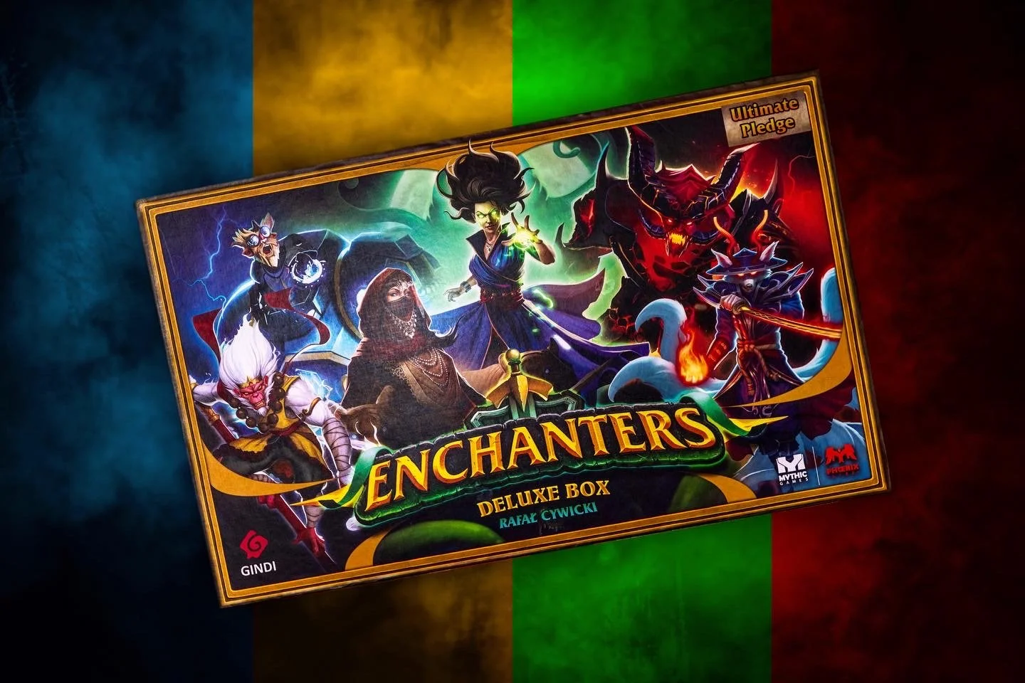 A colorful board game box titled "Enchanters Deluxe Box" with fantasy characters including a wizard, a mage, a demon, and a ninja, set against a background with the Irish flag colors of blue, yellow, and green.