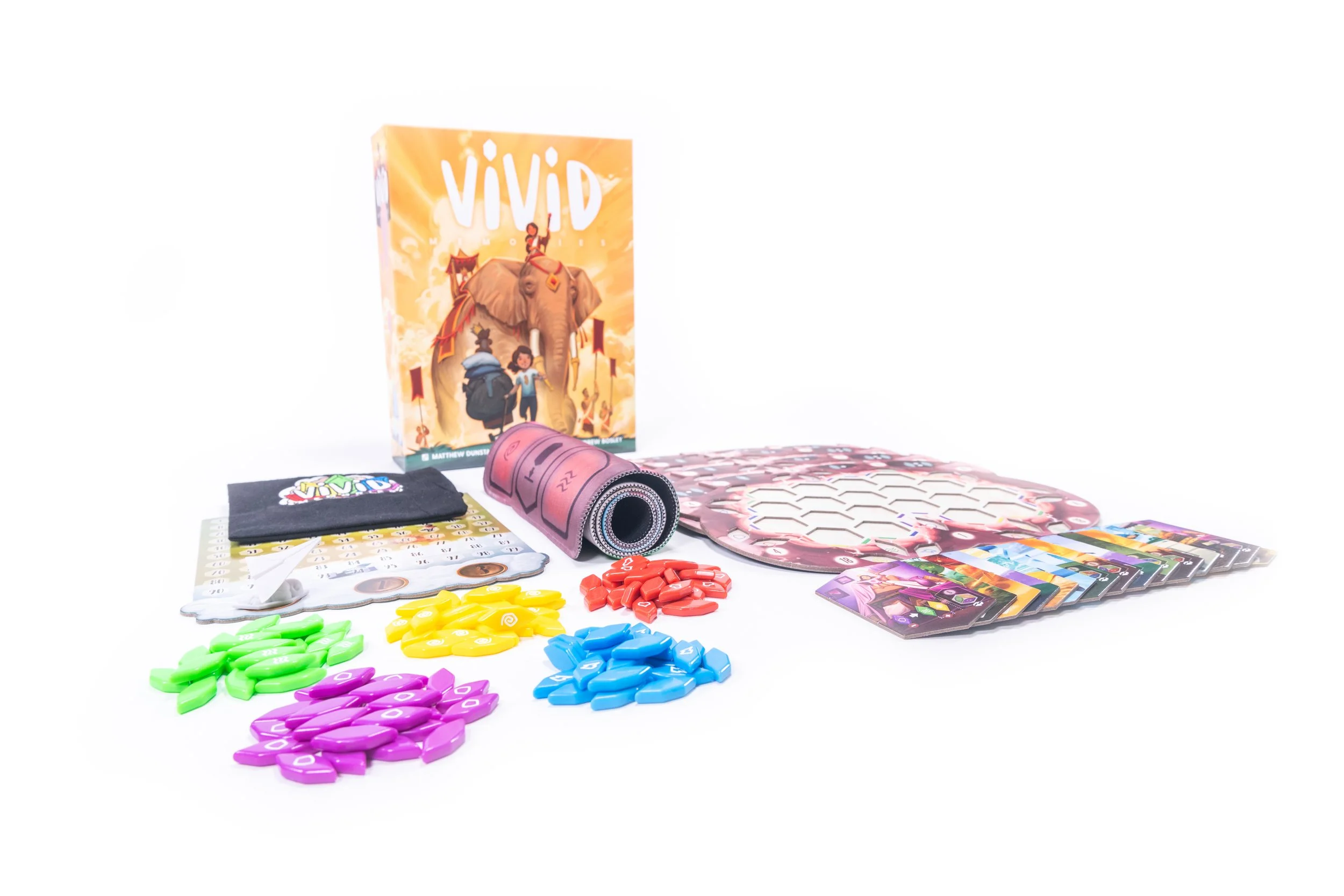 Board game components including colorful plastic tokens, cards, game board, and instruction booklet displayed on a white background.