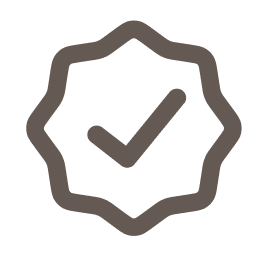 A badge icon with a checkmark in the center indicating approval or verification.