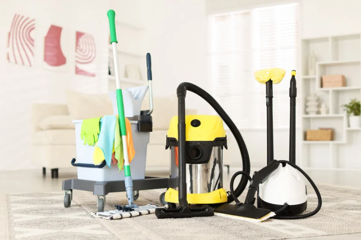 Vacuum cleaner, mop, and bucket used for residential and commercial cleaning services and floor maintenance.