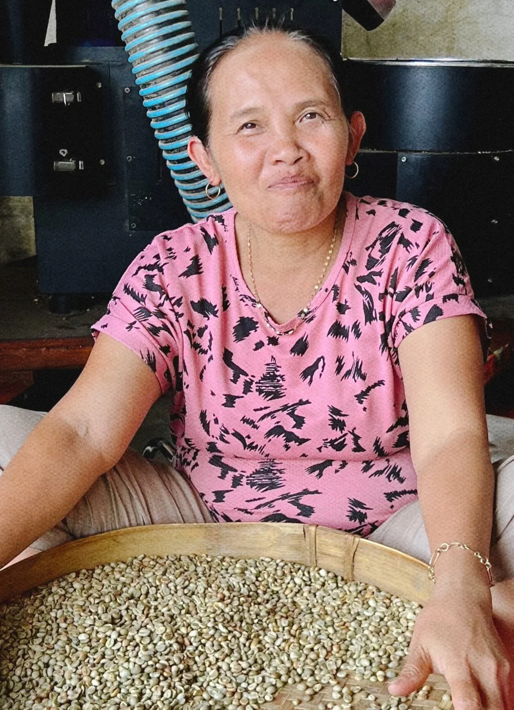 Our lovely Ibu hand sorting specialty green coffee beans in one of our partner farms located in East Java - Premium Indonesian Green Coffee Beans Exporter