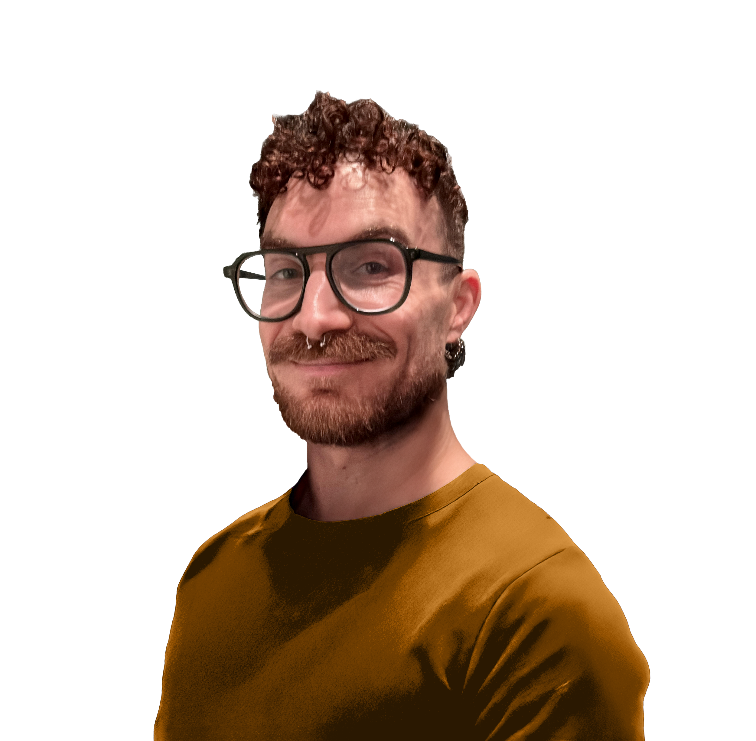 A man with curly hair, glasses, and a septum piercing, smiling, wearing a brown shirt.