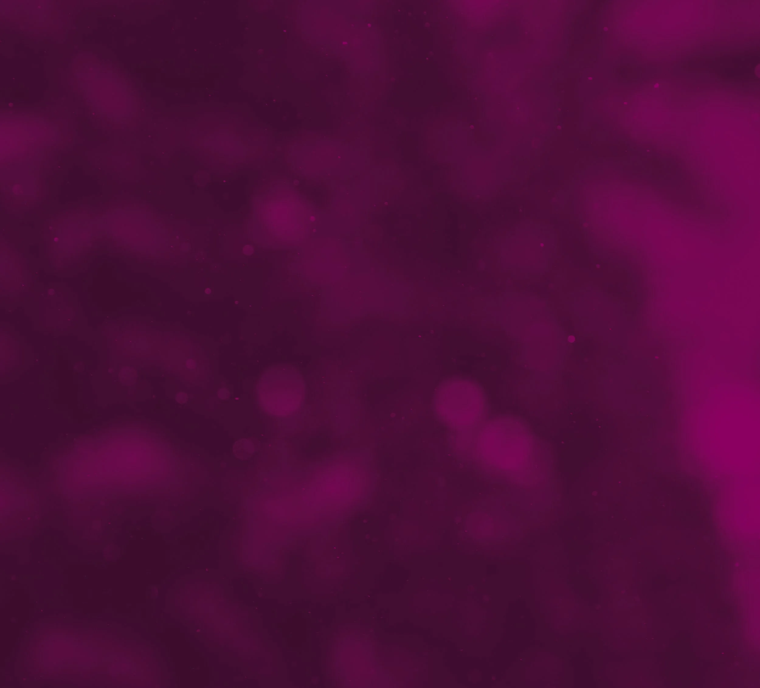 Blurred purple bokeh lights with dark background.