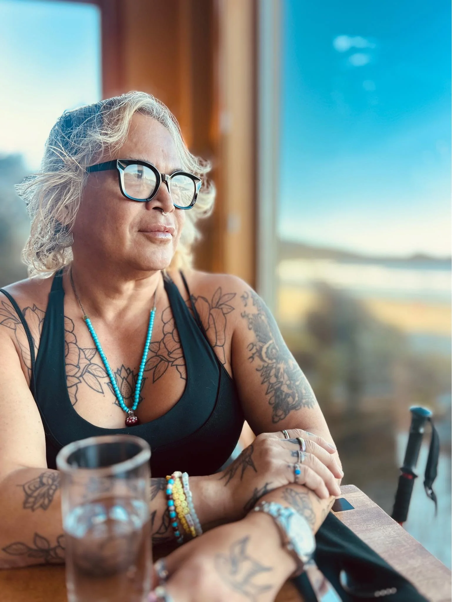 A photo of Nicki looking out a window taking in the beautiful landscape.