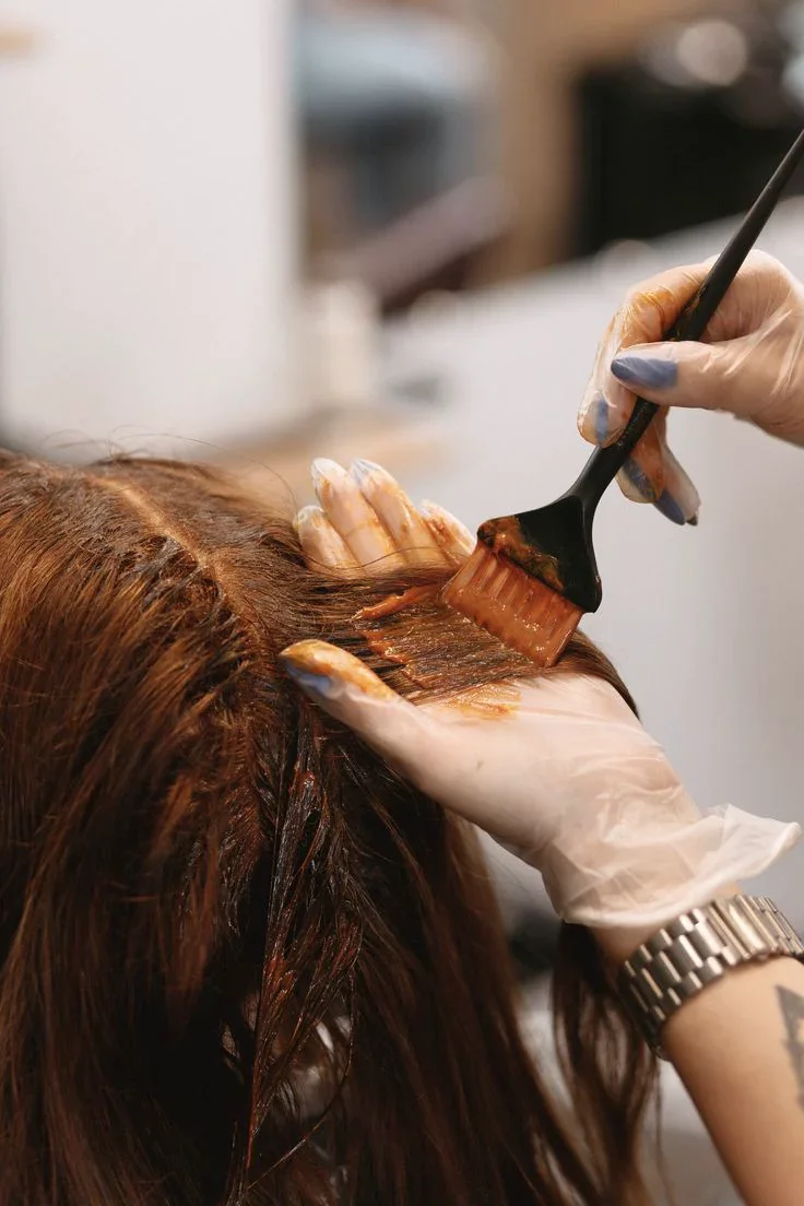 Custom hair color service being applied during a salon appointment.