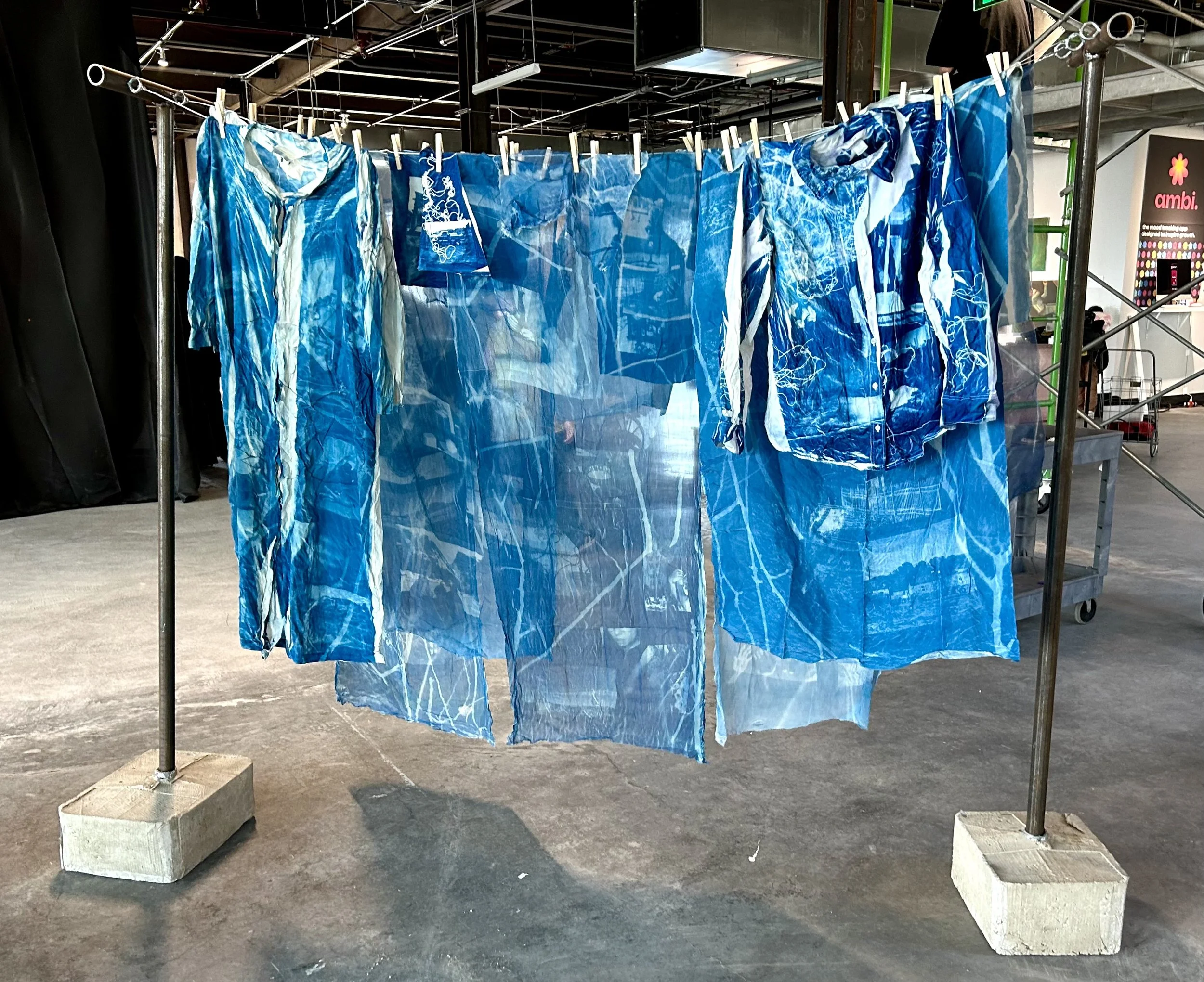 Records of Time. 2026. Cyanotype on second-hand silk and cotton, steel pipe, concrete, hanging wire. 72 x 72 in.