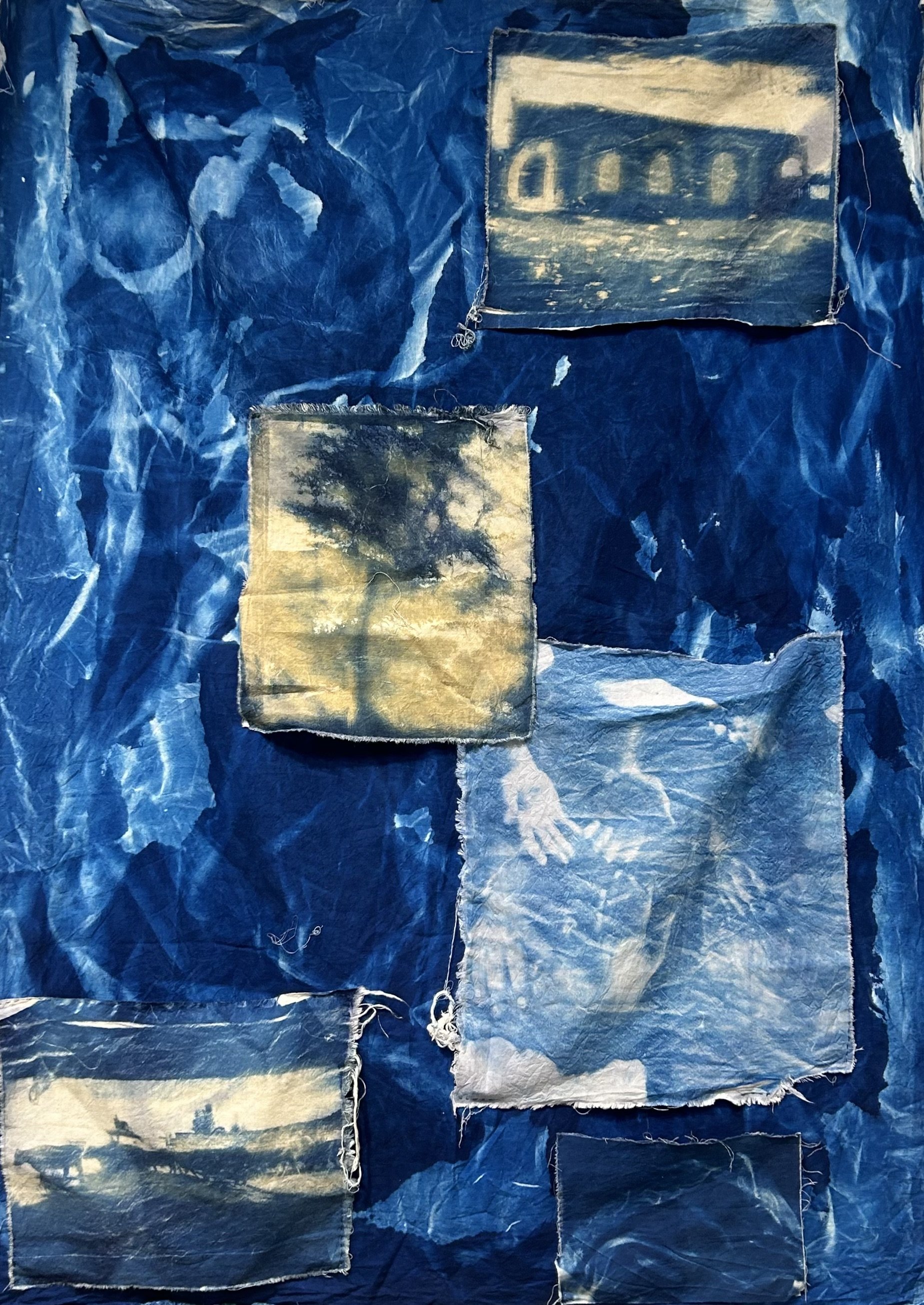 Through Hands. 2025. Cyanotype on second-hand fabric. 108 x 144 in.