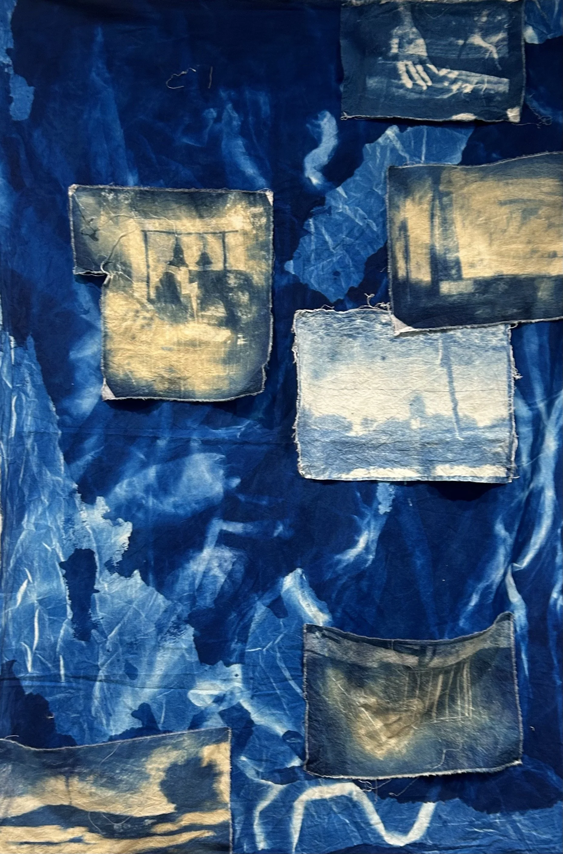 Through Hands. 2025. Cyanotype on second-hand fabric. 108 x 144 in.