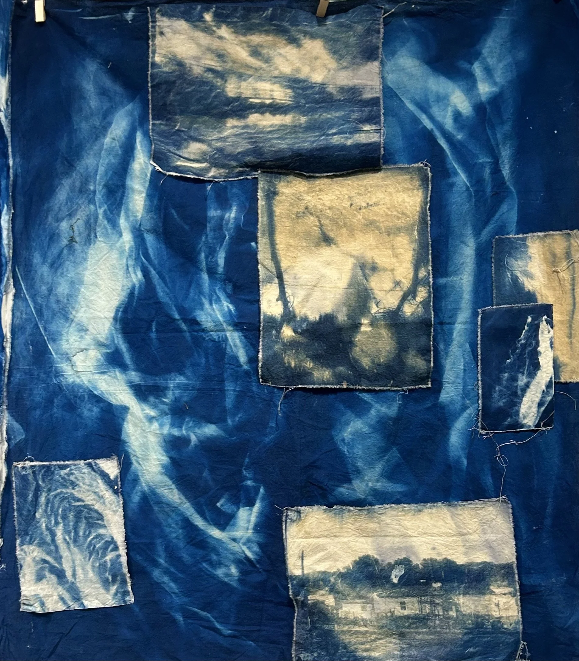 Through Hands. 2025. Cyanotype on second-hand fabric. 108 x 144 in.