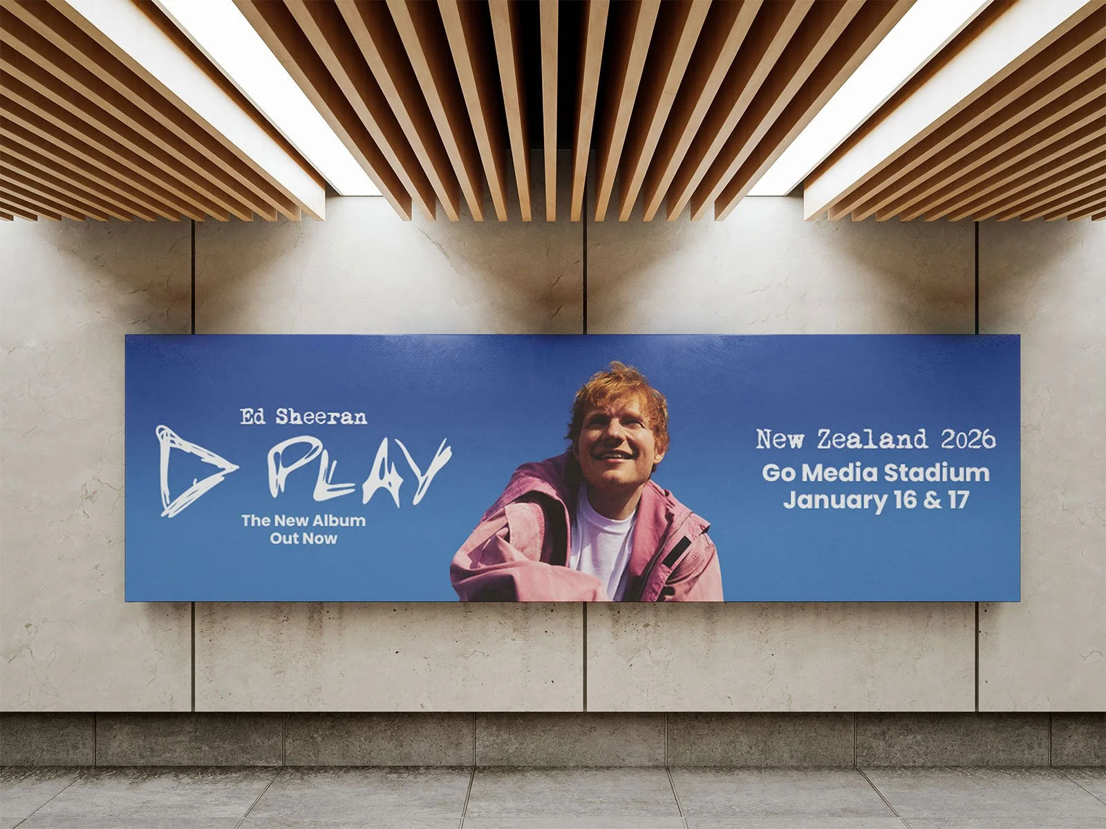 Billboard advertisement for Ed Sheeran's new album titled "PLAY" featuring a smiling Ed Sheeran in a pink jacket, with event details for a concert in New Zealand at Go Media Stadium on January 16 and 17, 2026.