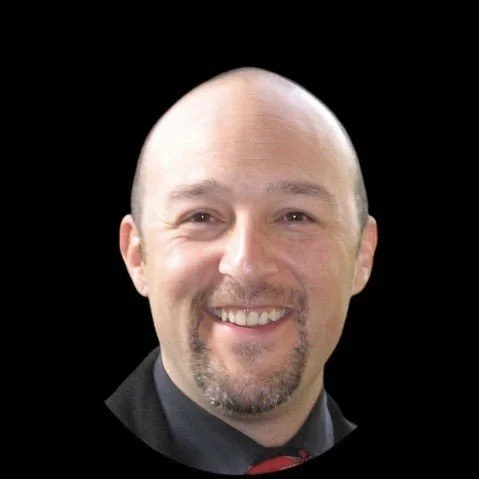 Headshot of a bald man with a goatee smiling