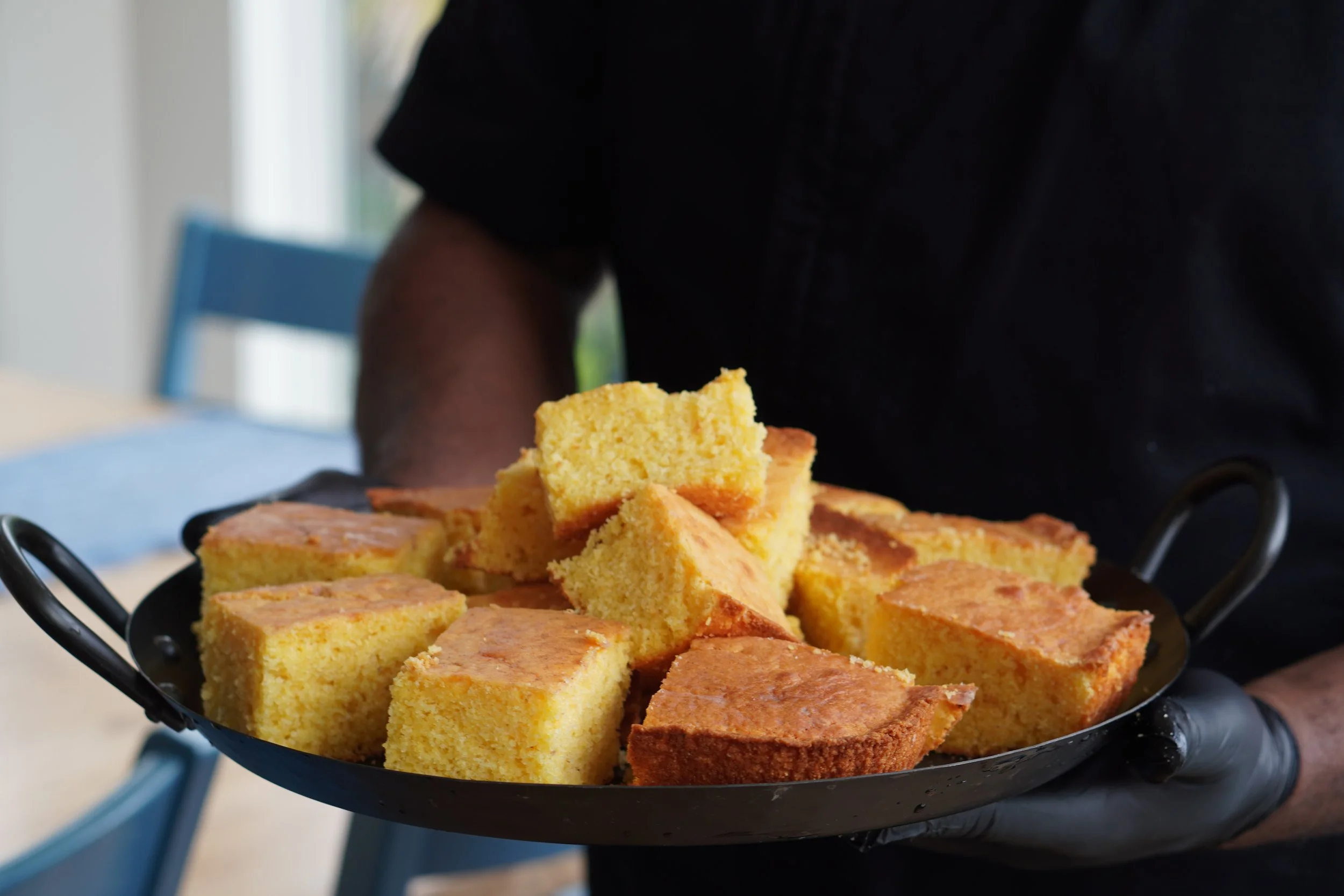 Cast iron skillet of homemade cornbread from Tater's Lowcountry Kitchen, Charleston SC