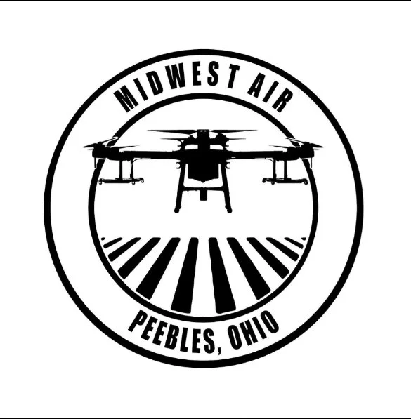 Black and white logo featuring a drone flying above runway lines inside a circular border; text reads 'Midwest Air Peebles, Ohio'.