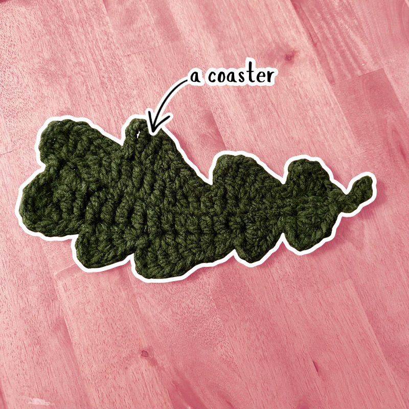 A crochet coaster shaped like an oak leaf