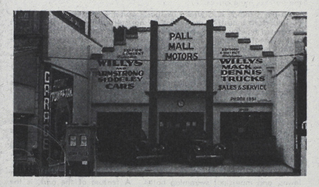 Black and white photo of the Pall Mall Motors building with advertisements for Willys and Armstrong Siddeley Cars, and Willys and Denno Trucks, featuring sales, service, and parts.
