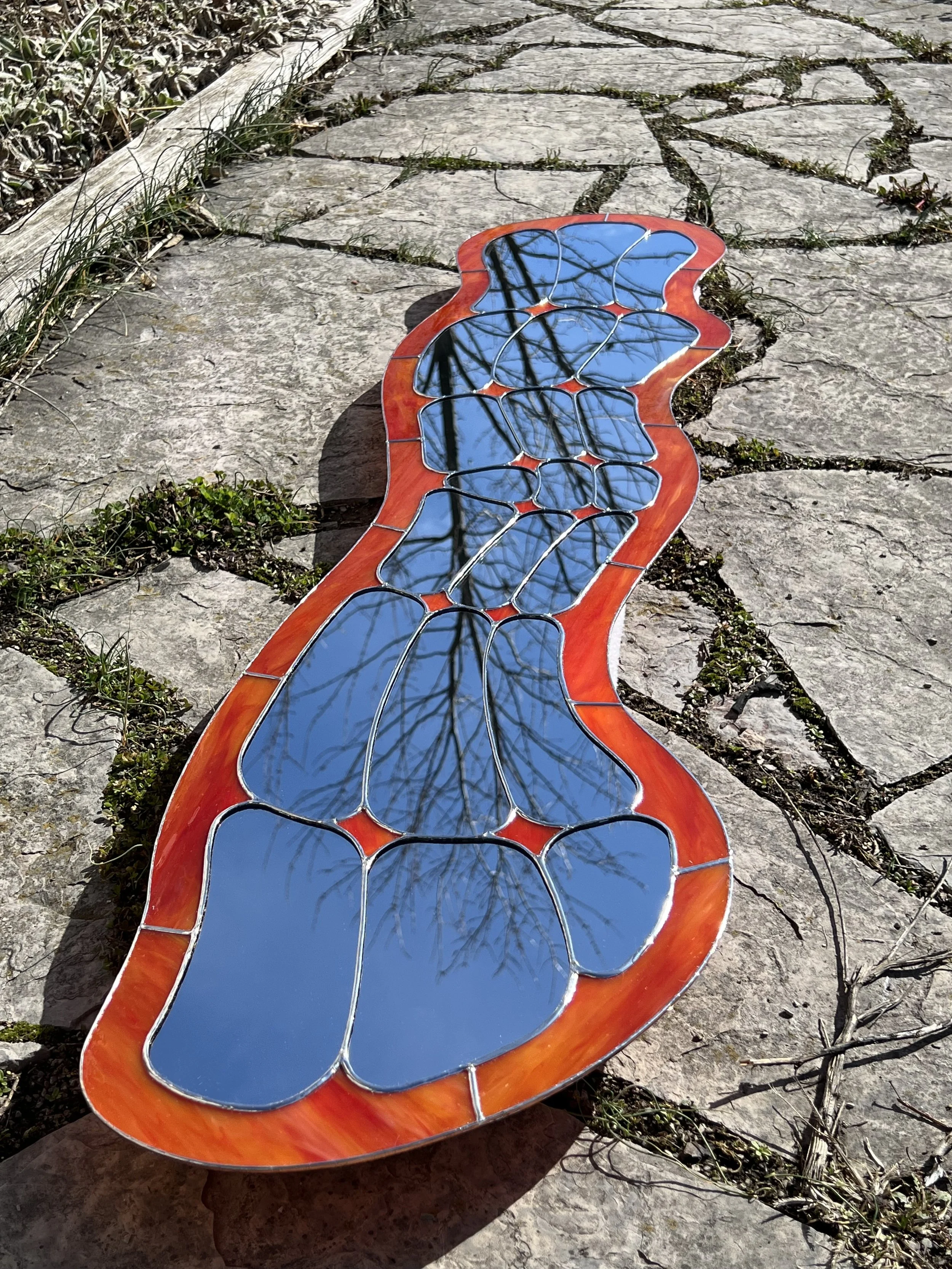 artisan stained glass mirror, hand crafted design, with a flowing water like design. one of a kind art