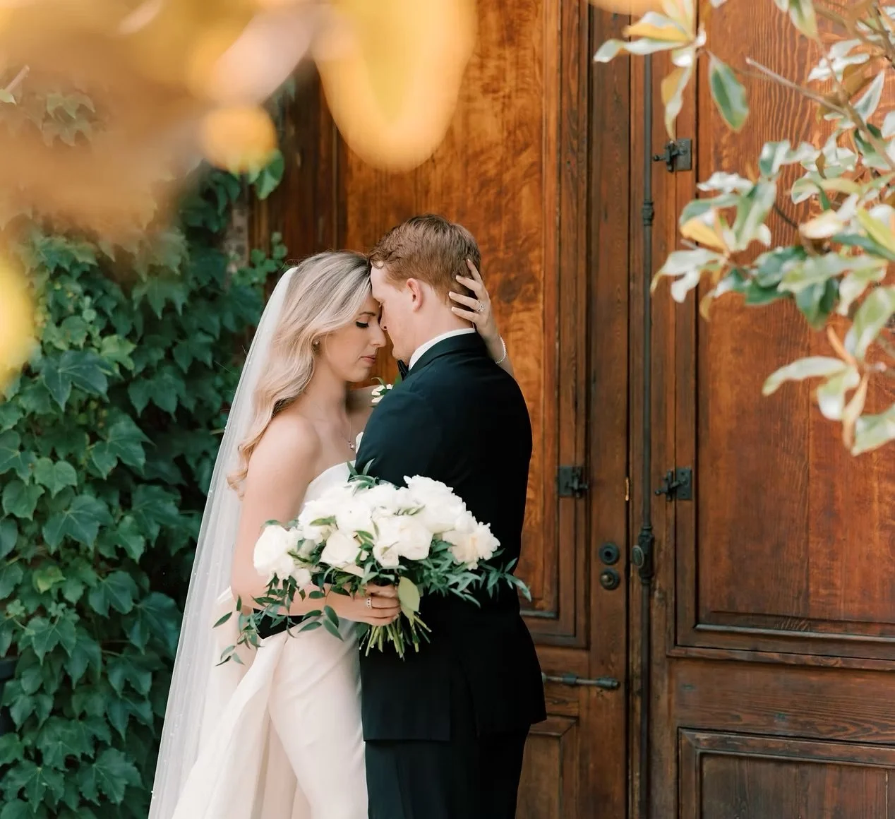 Close-up of a person playing an acoustic guitar, focusing on their hand pressing on the strings.