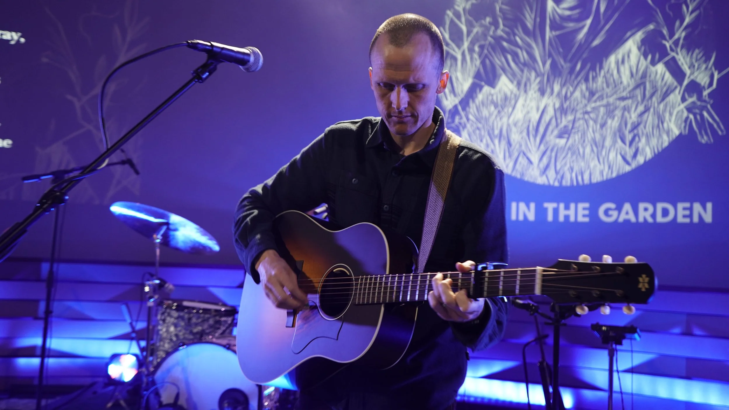 A Member of Poor Bishop Hooper Plays Guitar