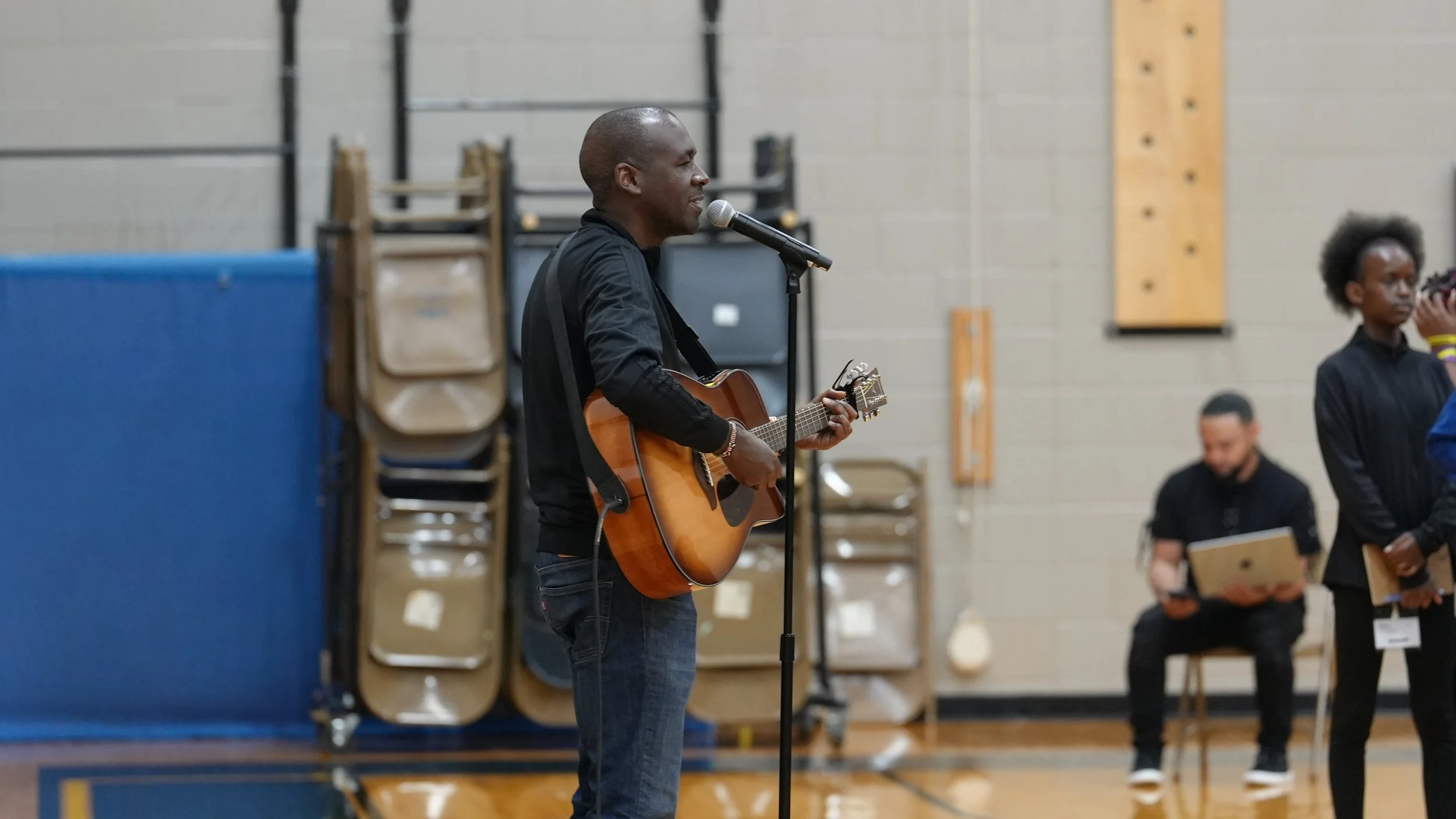 A guitar player leading the All Nations Breakthrough Youth in Moment of Praise And Worship