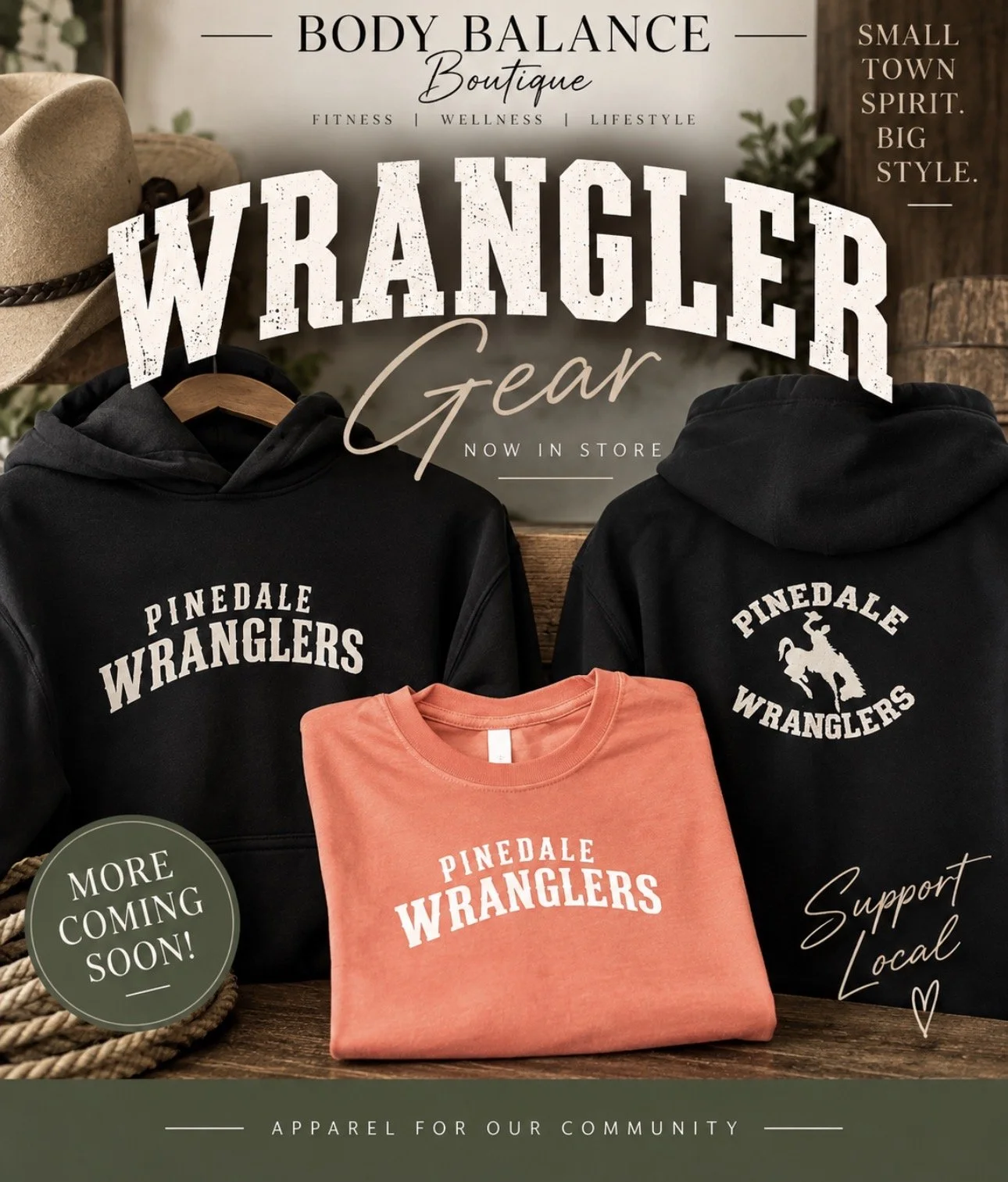 A promotional poster for the Body Balance Boutique featuring Wrangler gear, including black hoodies with Pinedale Wrangler logos and a folded pink Wrangler t-shirt, with a hat and rope in the background, and text promoting local apparel and upcoming stock.