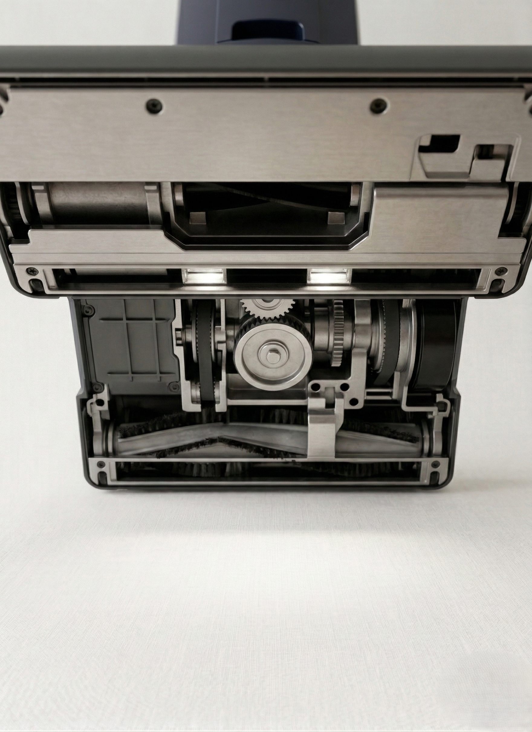 Close-up of the internal mechanical components of an electric typewriter, including gears and rollers.