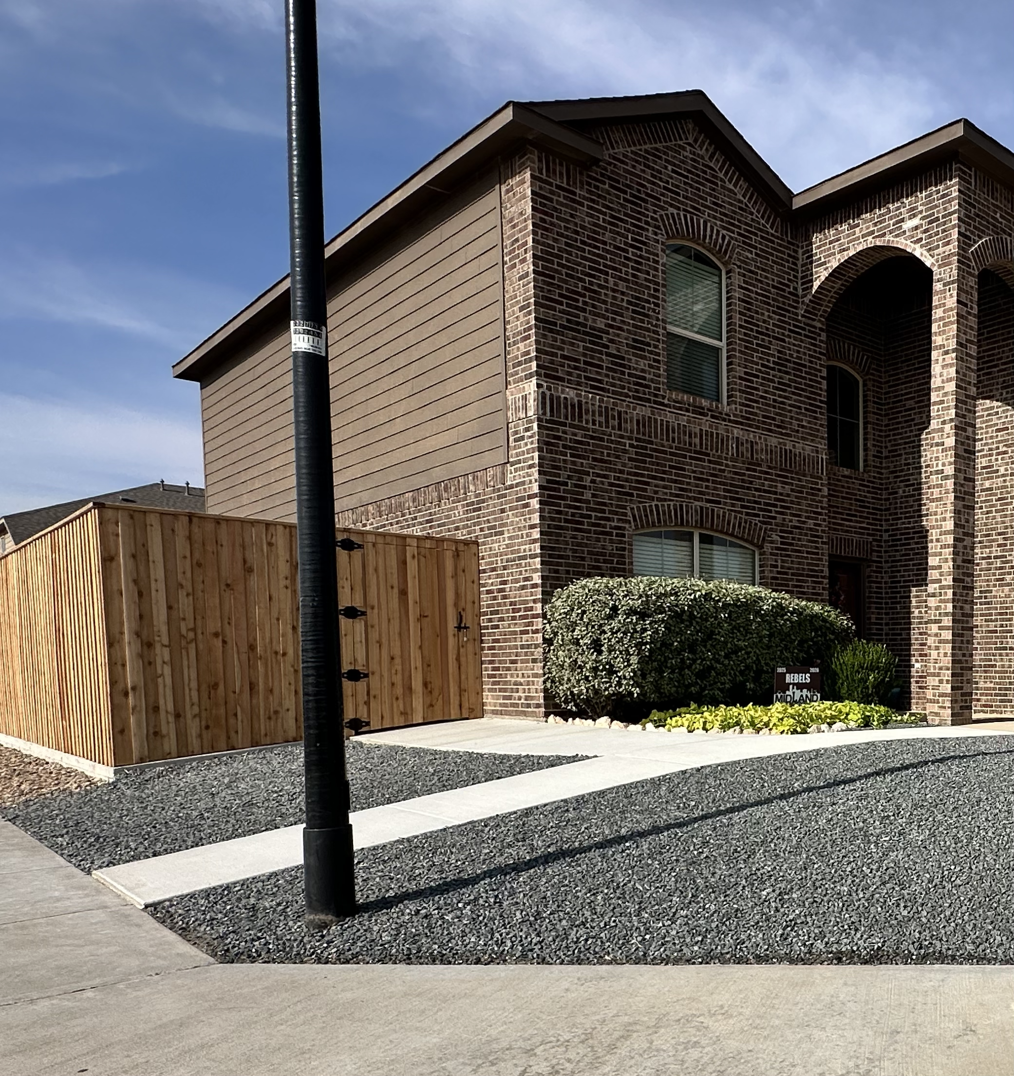 After - Custom Privacy Fence, Concrete & Rocks Installation Completed by Shep's Landscaping & Construction